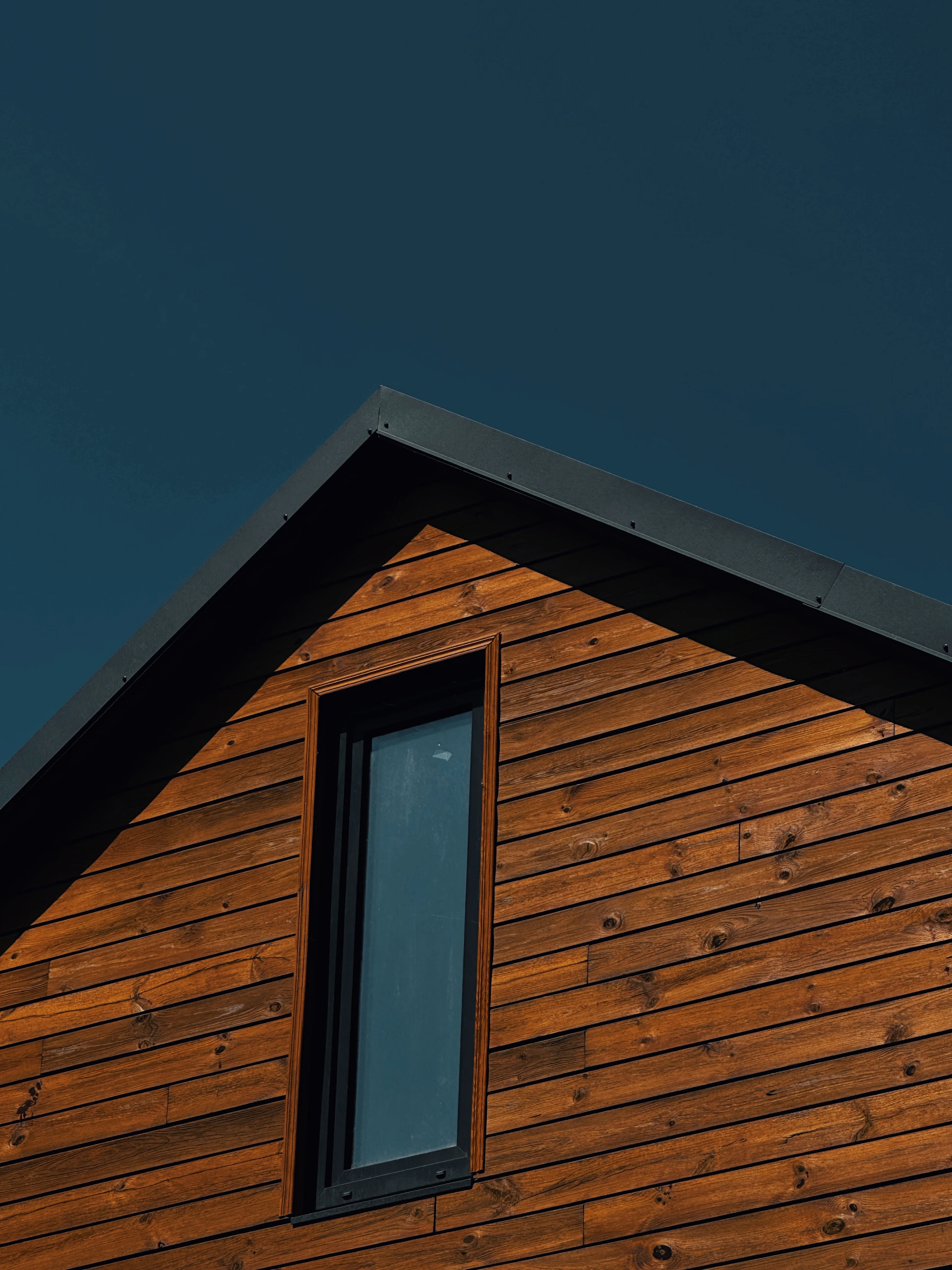 Wooden house facade with a dark sky