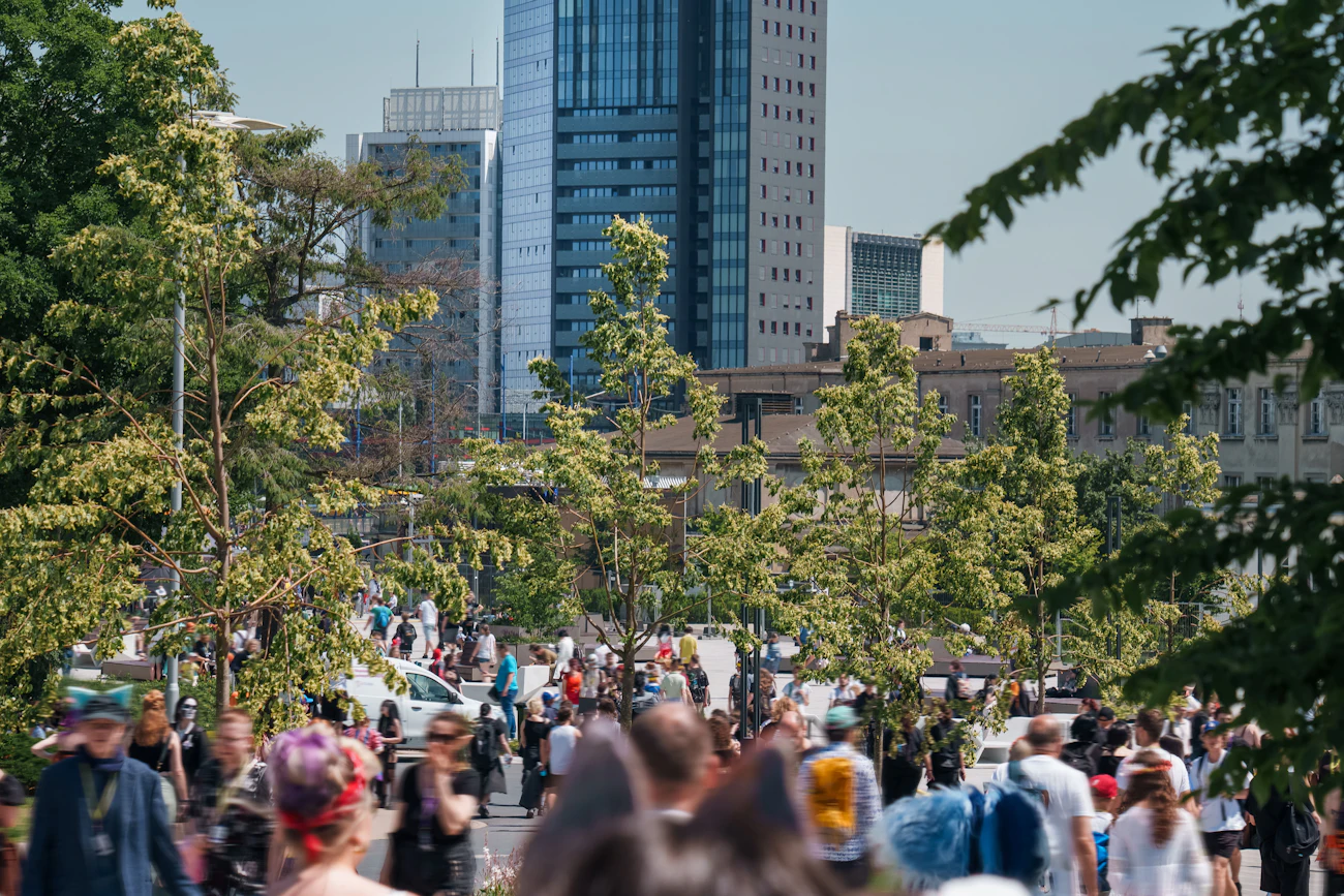 A crowd of people moving through a vibrant urban place