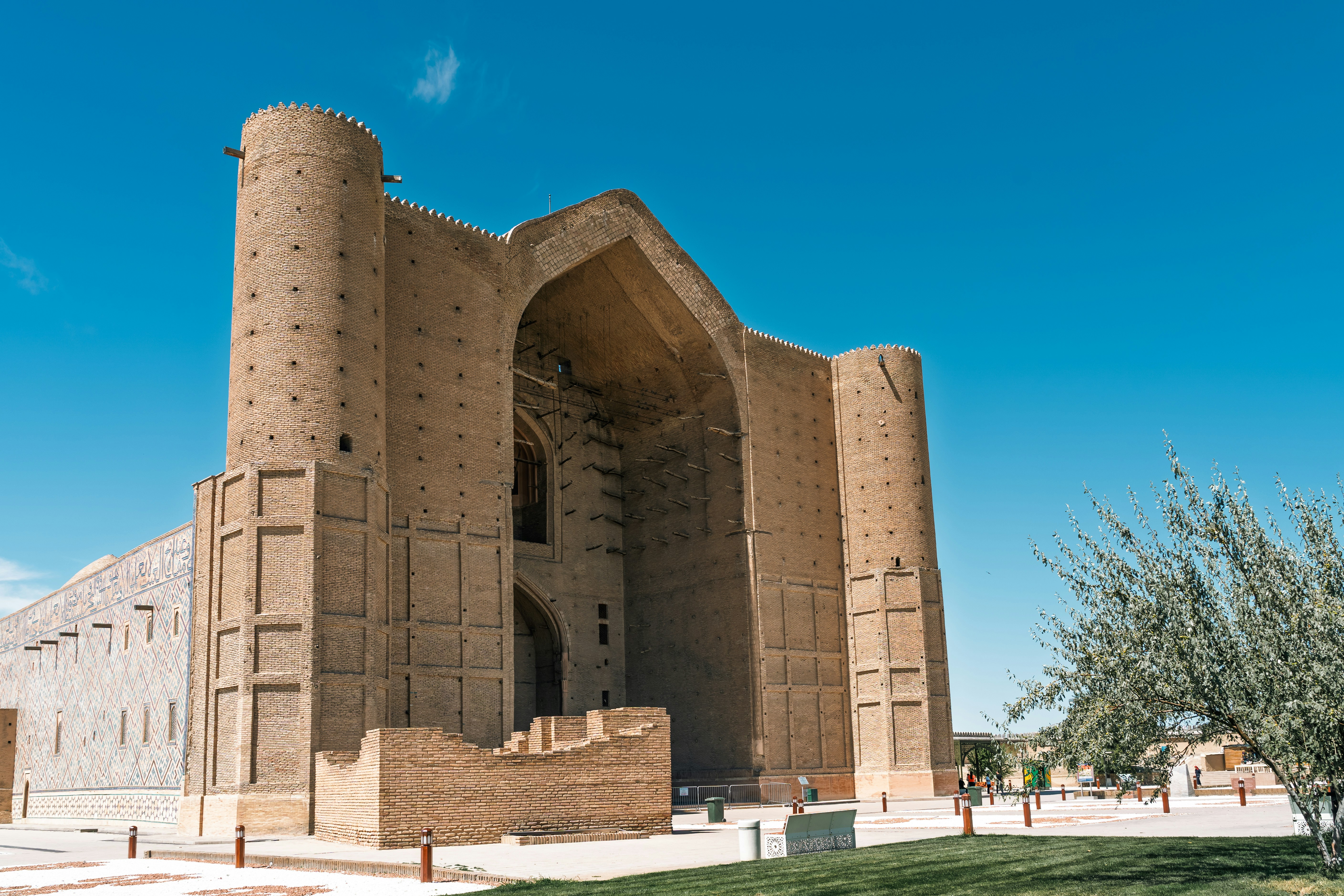 Ancient brick mausoleum under a clear blue sky
