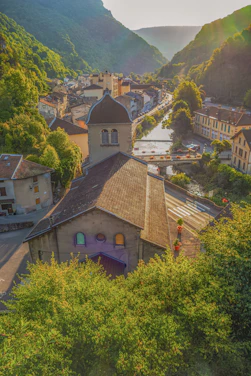 Village nestled in a green mountain valley at sunset
