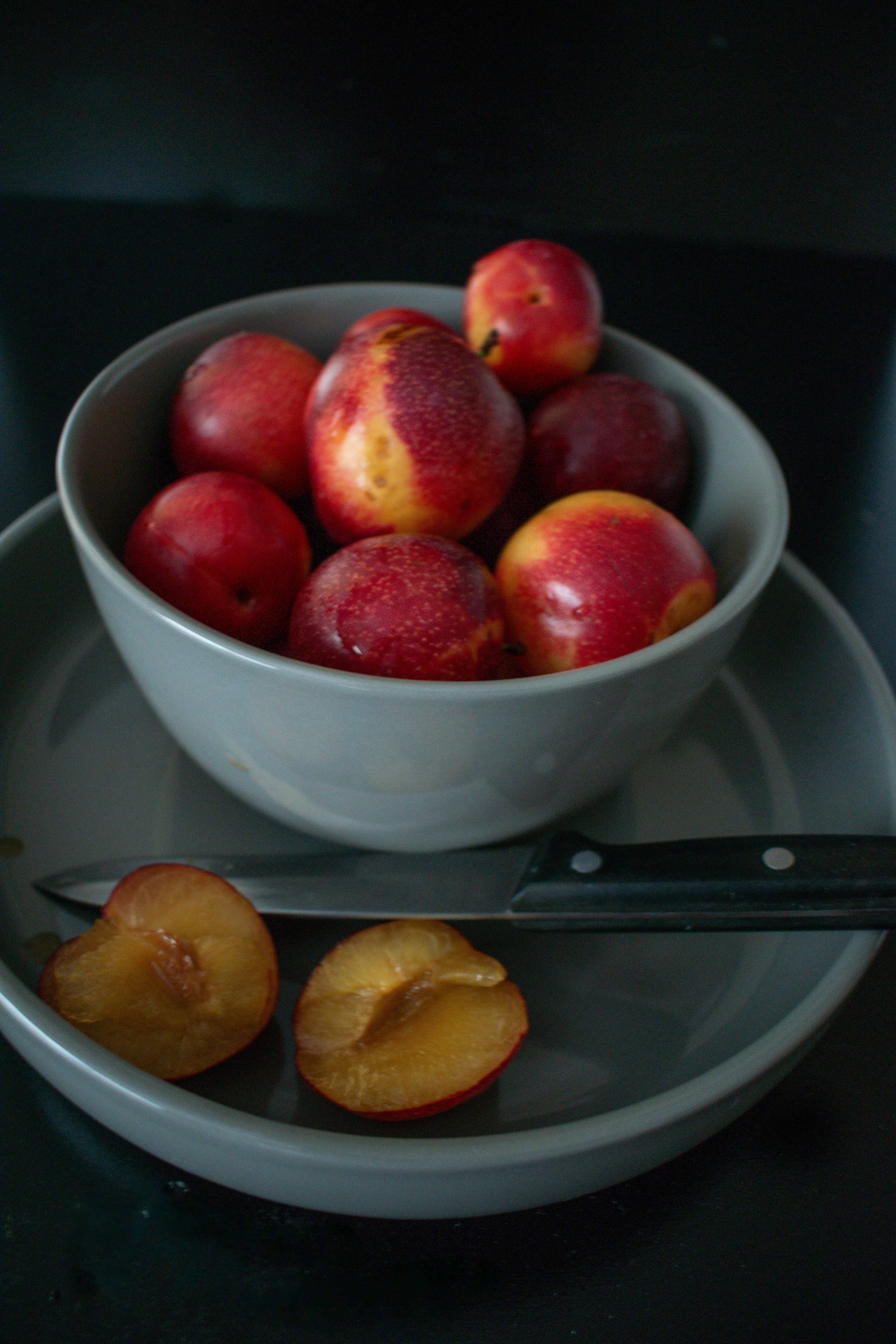 Bowl of nectarines with two sliced halves