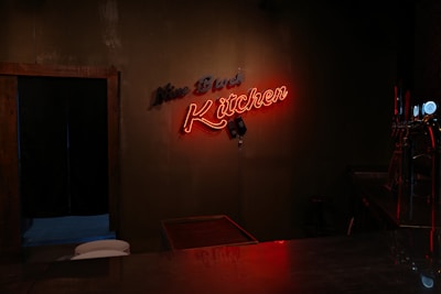 Orange neon sign glowing in a dark room