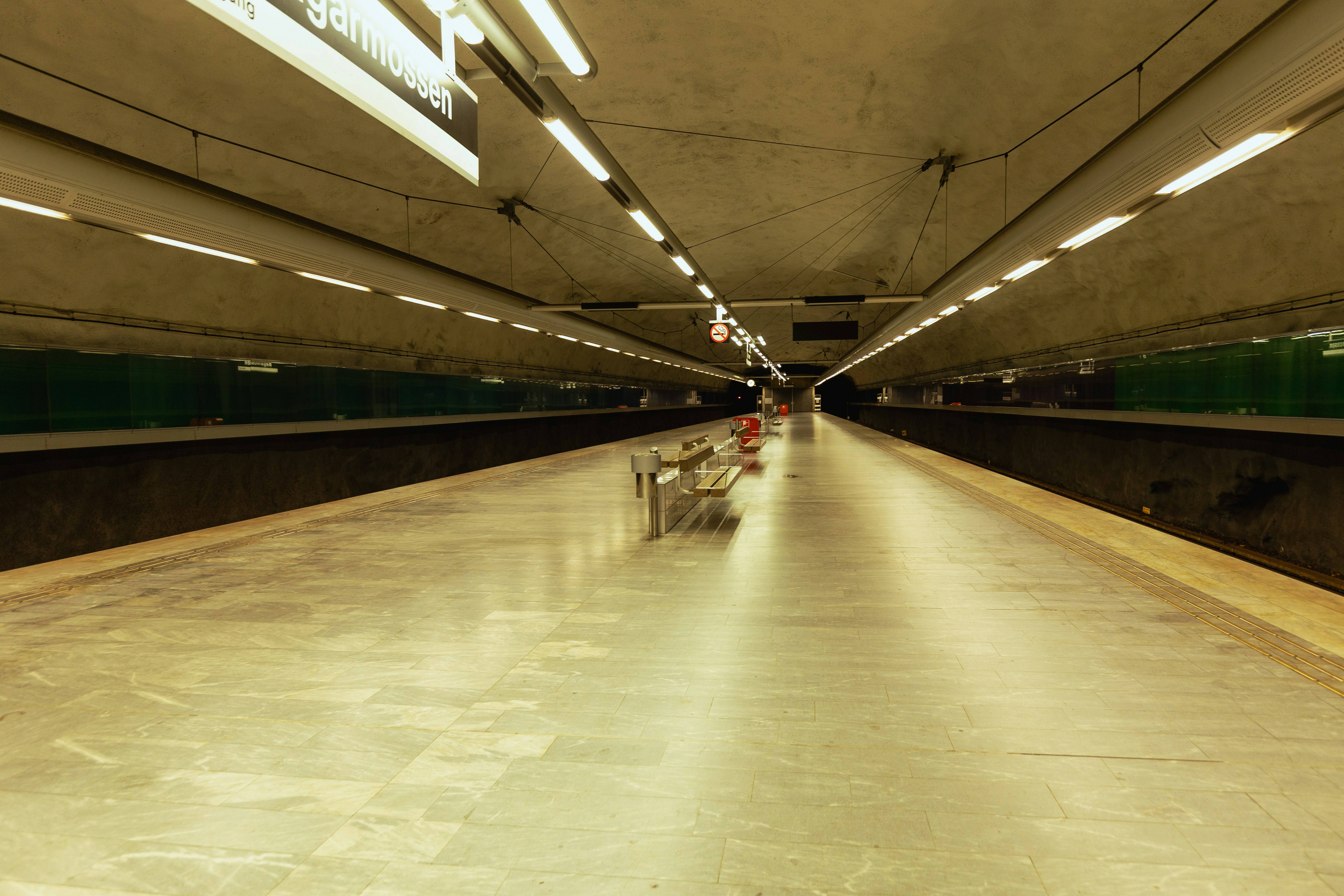 Empty train station platform with overhead lights