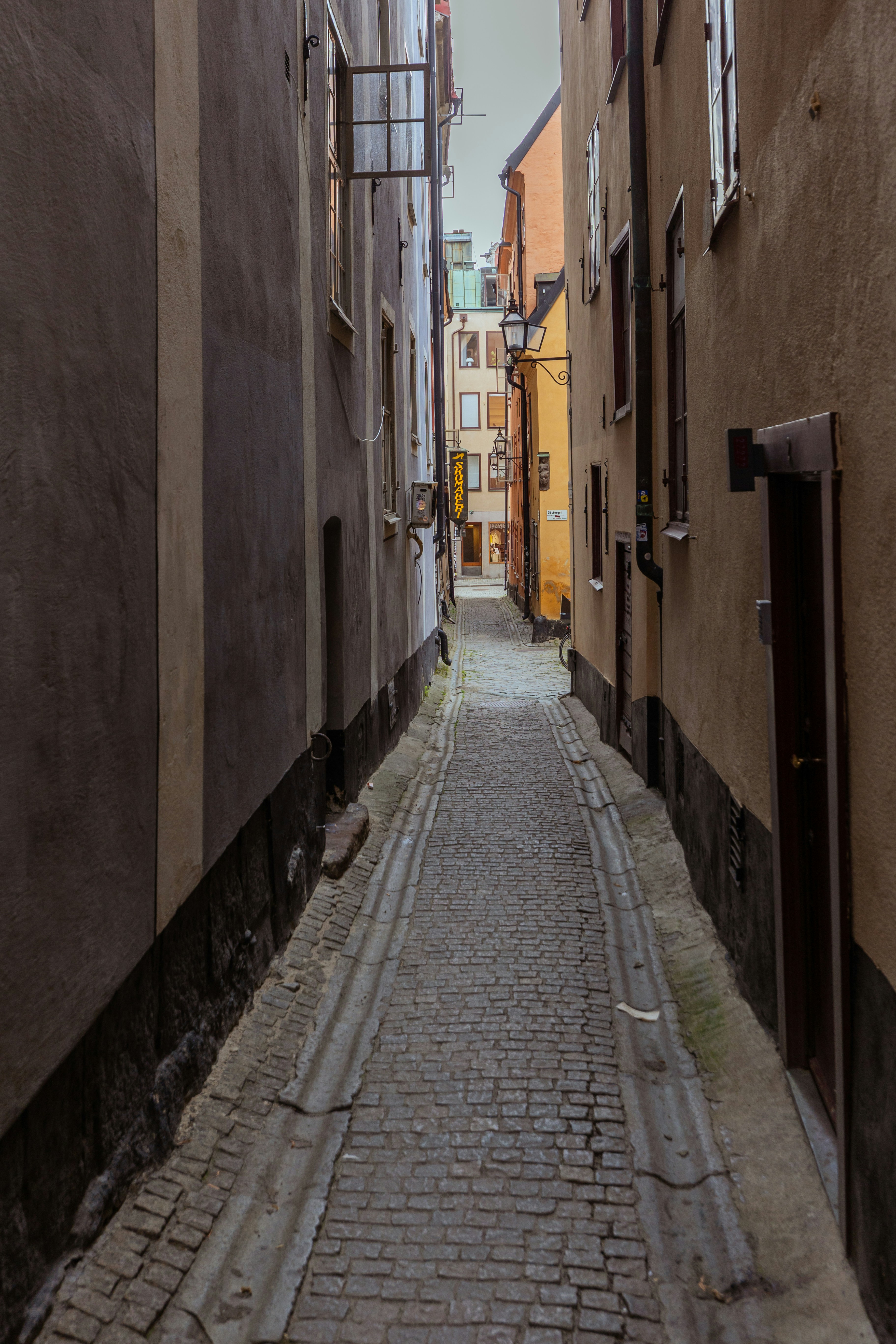 Narrow cobblestone alley between old buildings