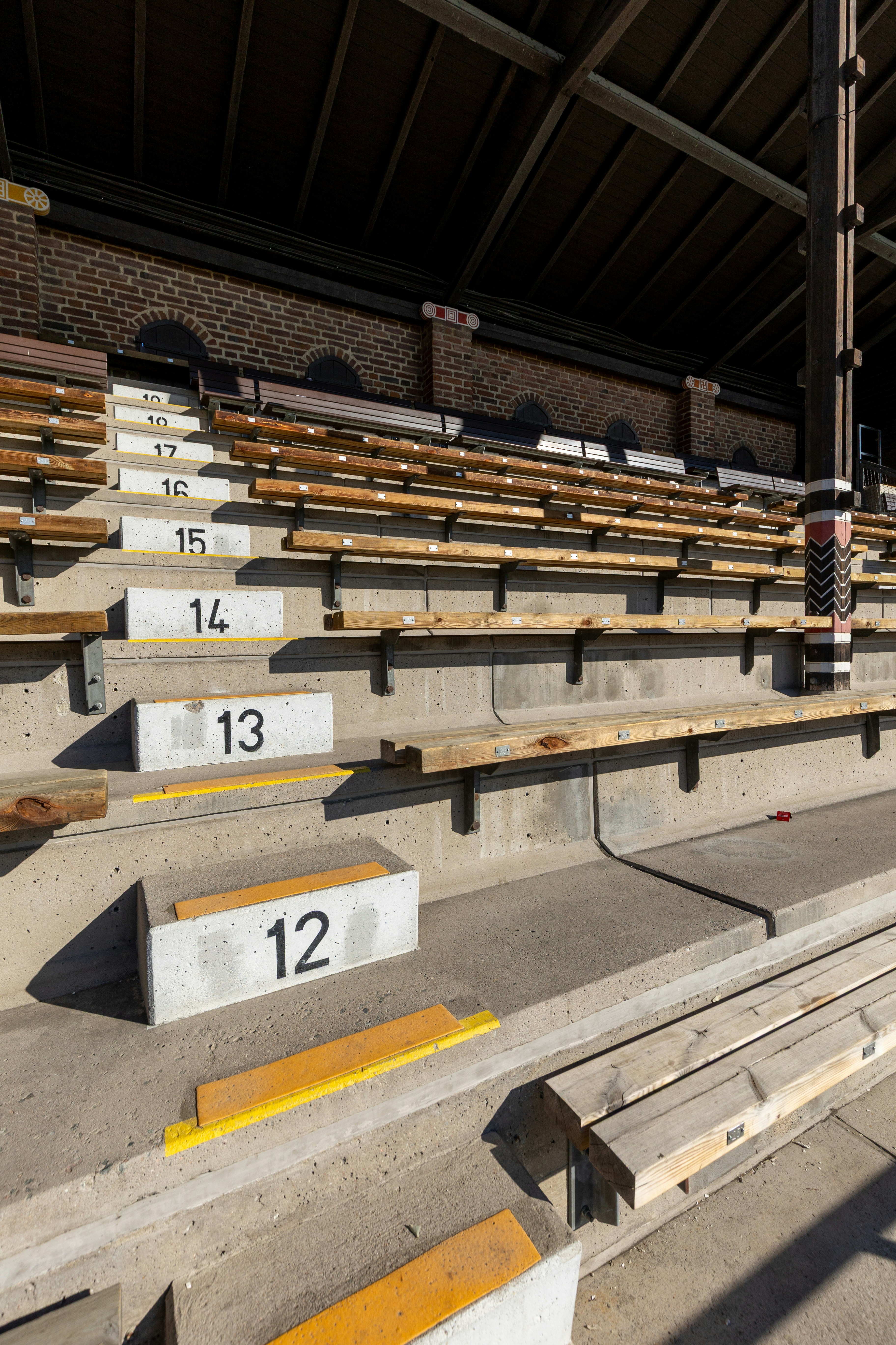 Empty wooden stadium seats with numbered markers