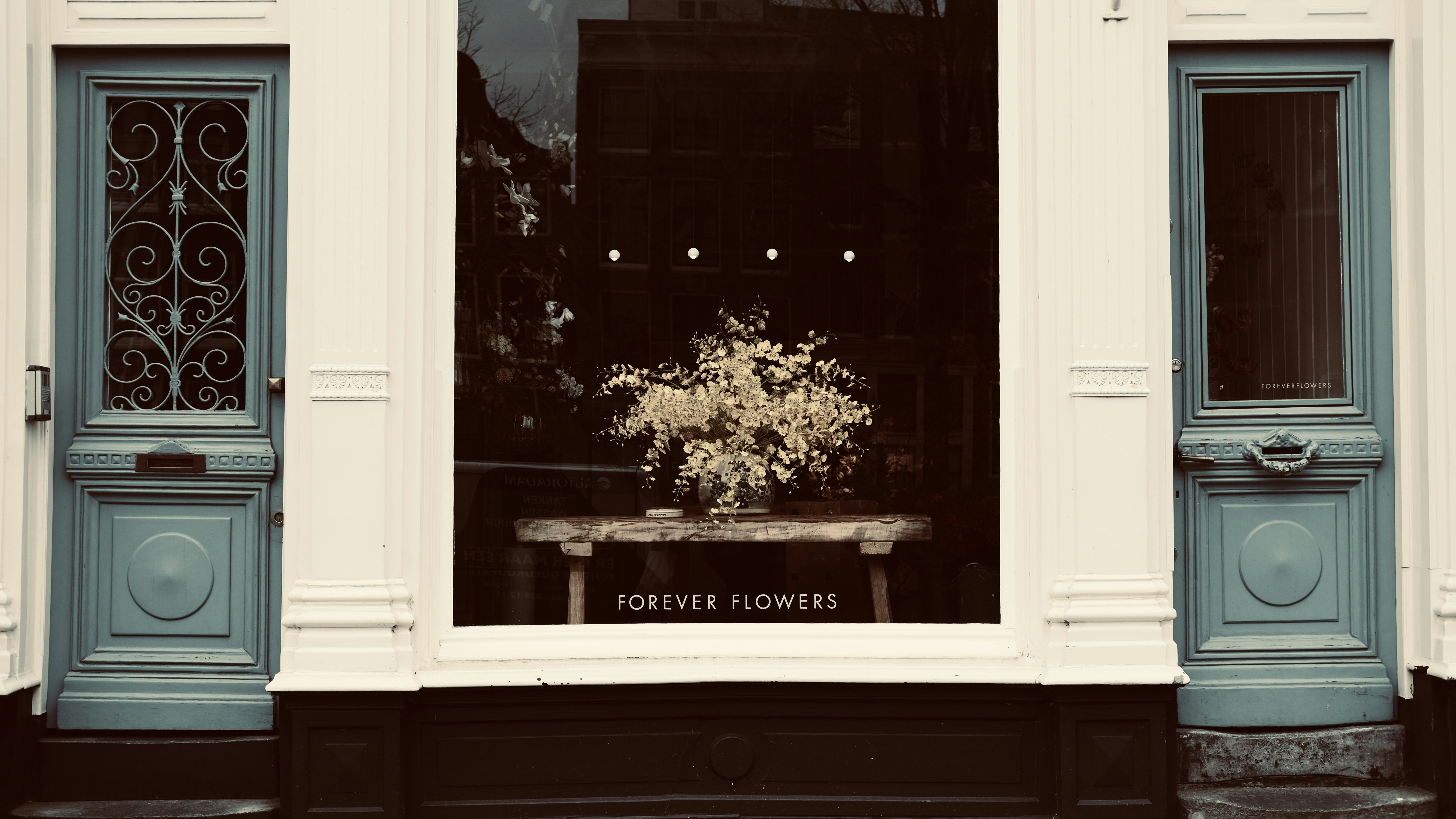 두 개의 청록색 문이 어두운 포스터 옆에 있습니다.