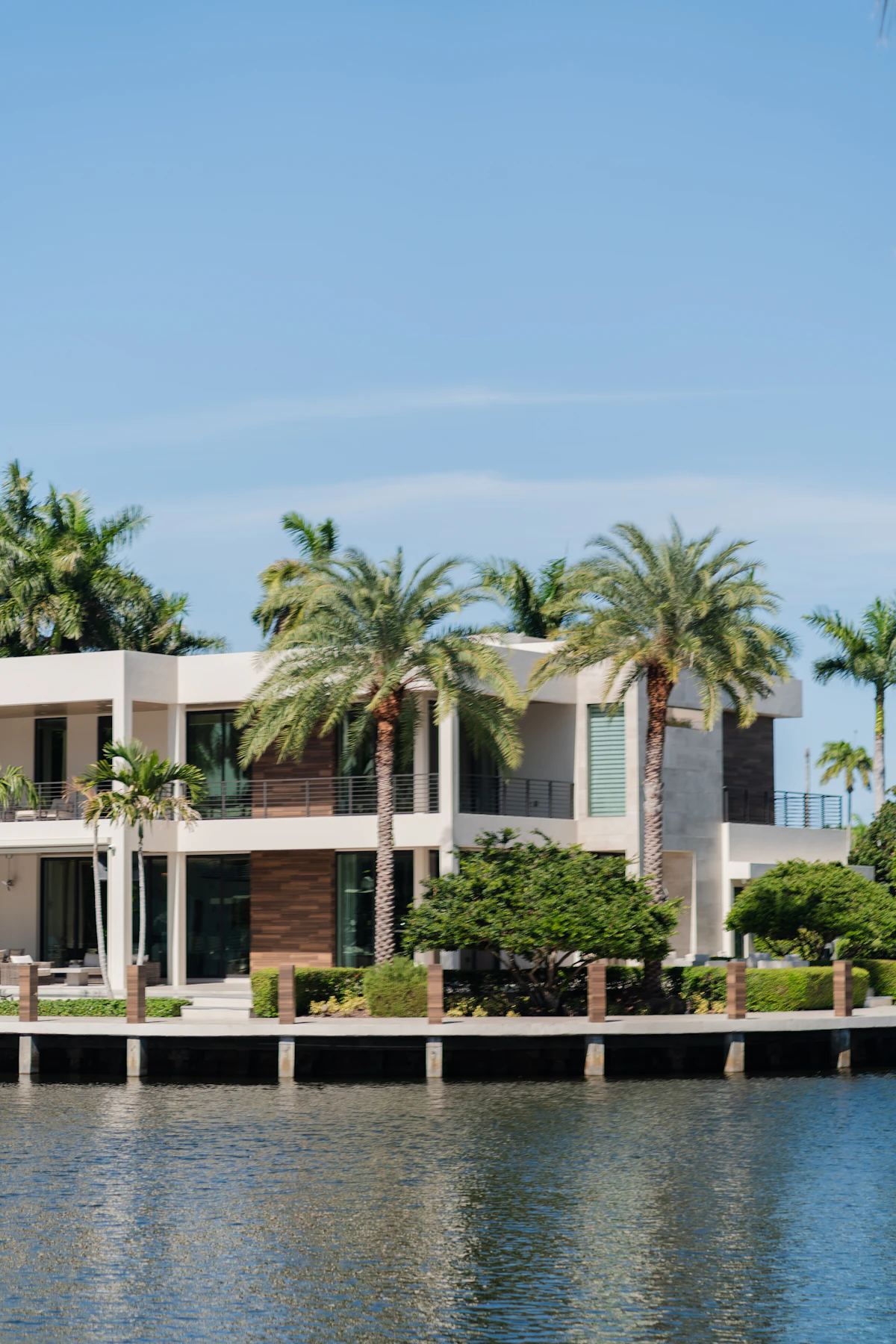 Luxury waterfront home with palms and water access