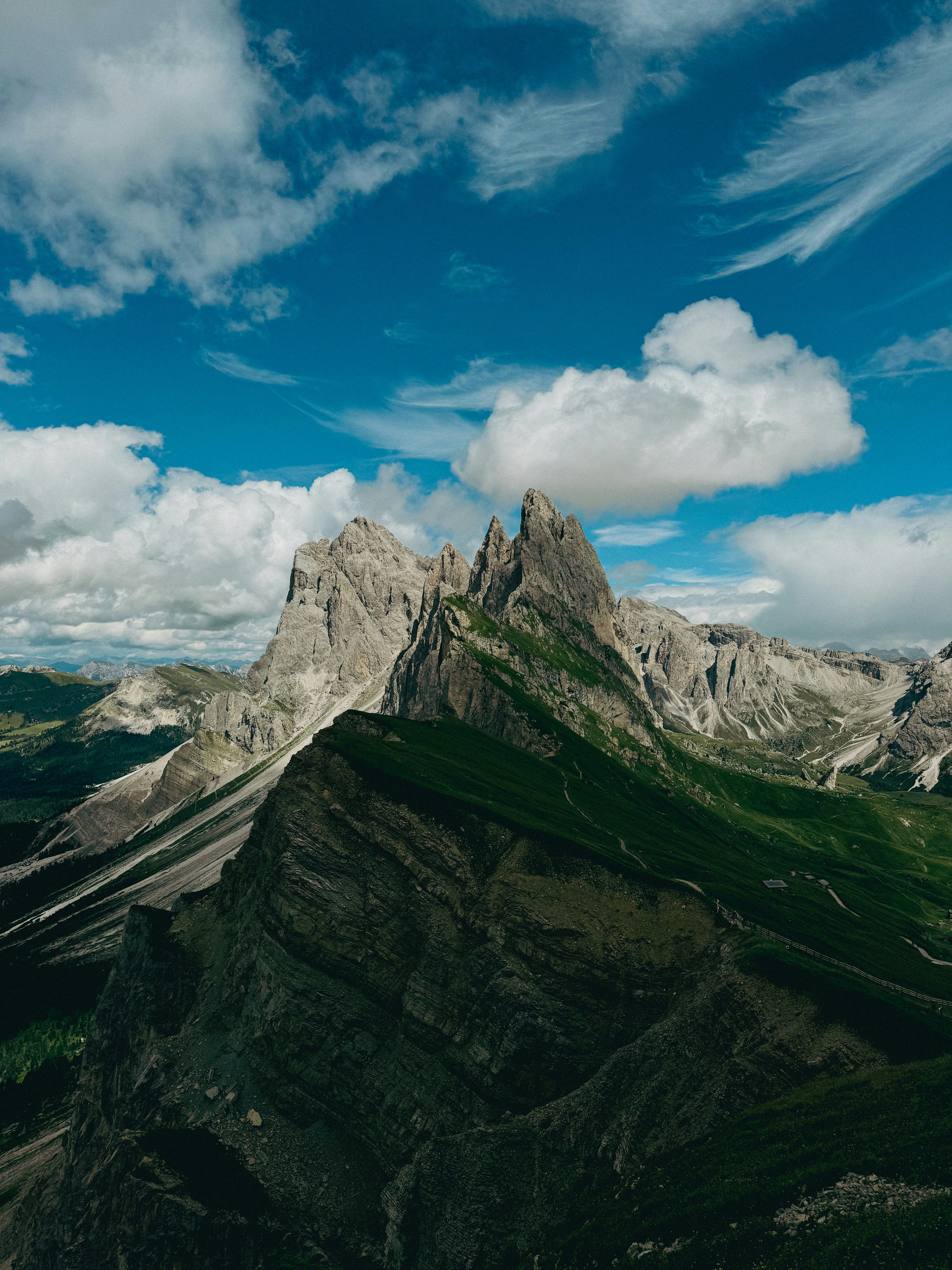 Jagged mountain peaks under a cloudy blue sky