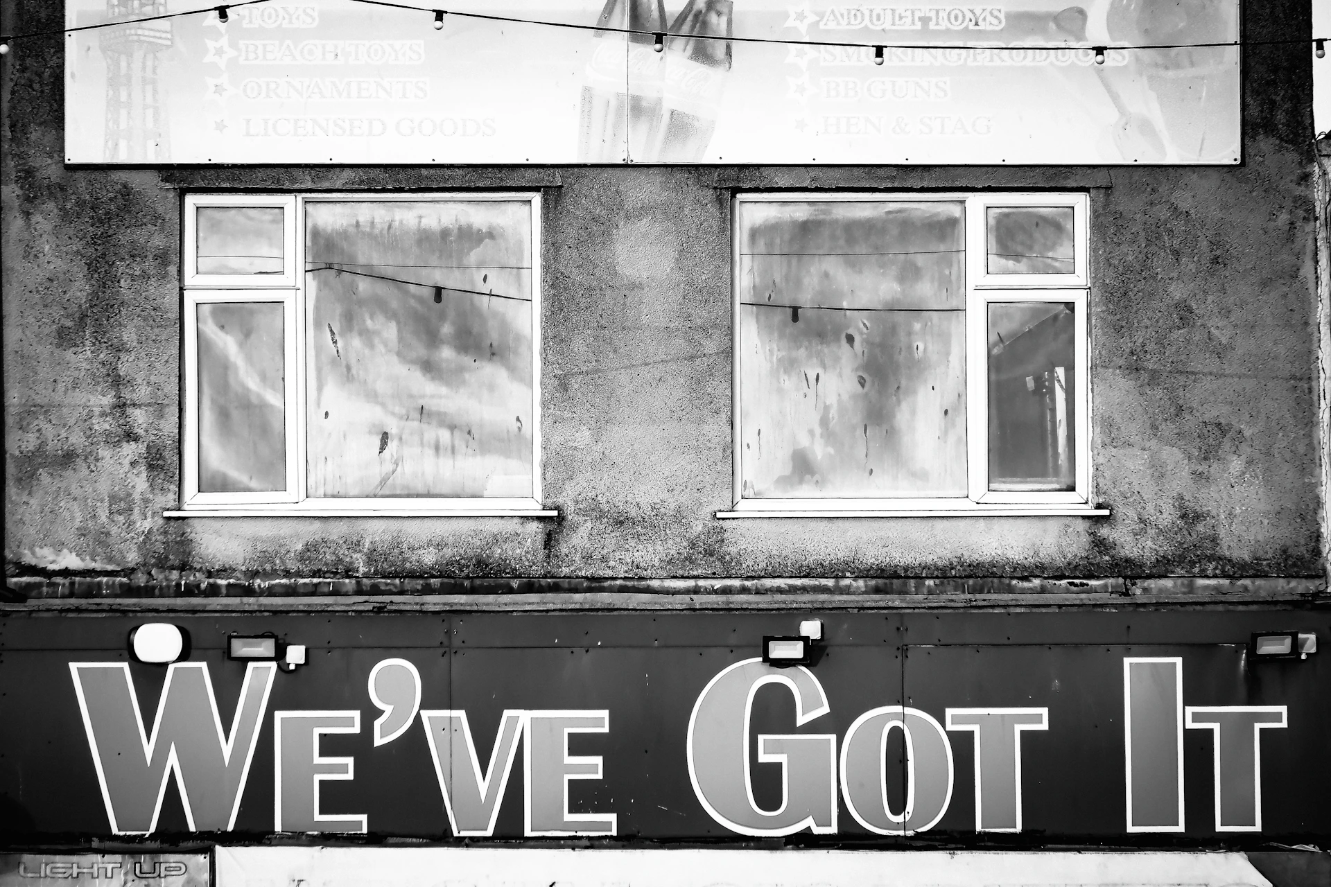 Two windows above a sign that says we've got it