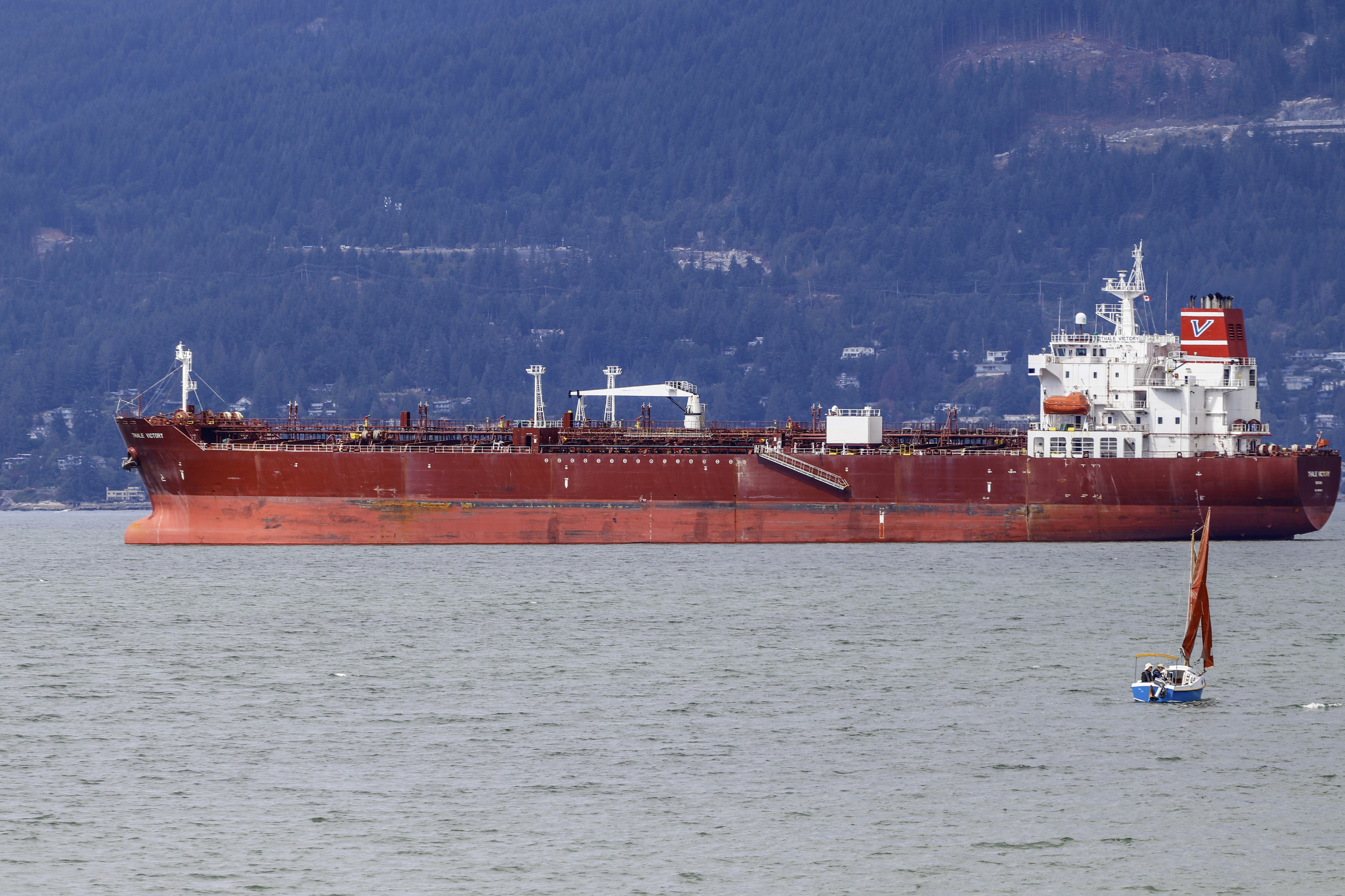 Petroleum oil tanker ship anchored in Vancouver English Bay empty floats high in the water awaiting loading from the TMX Trans Mountain Expansion diluted bitumen pipeline in Burnaby.