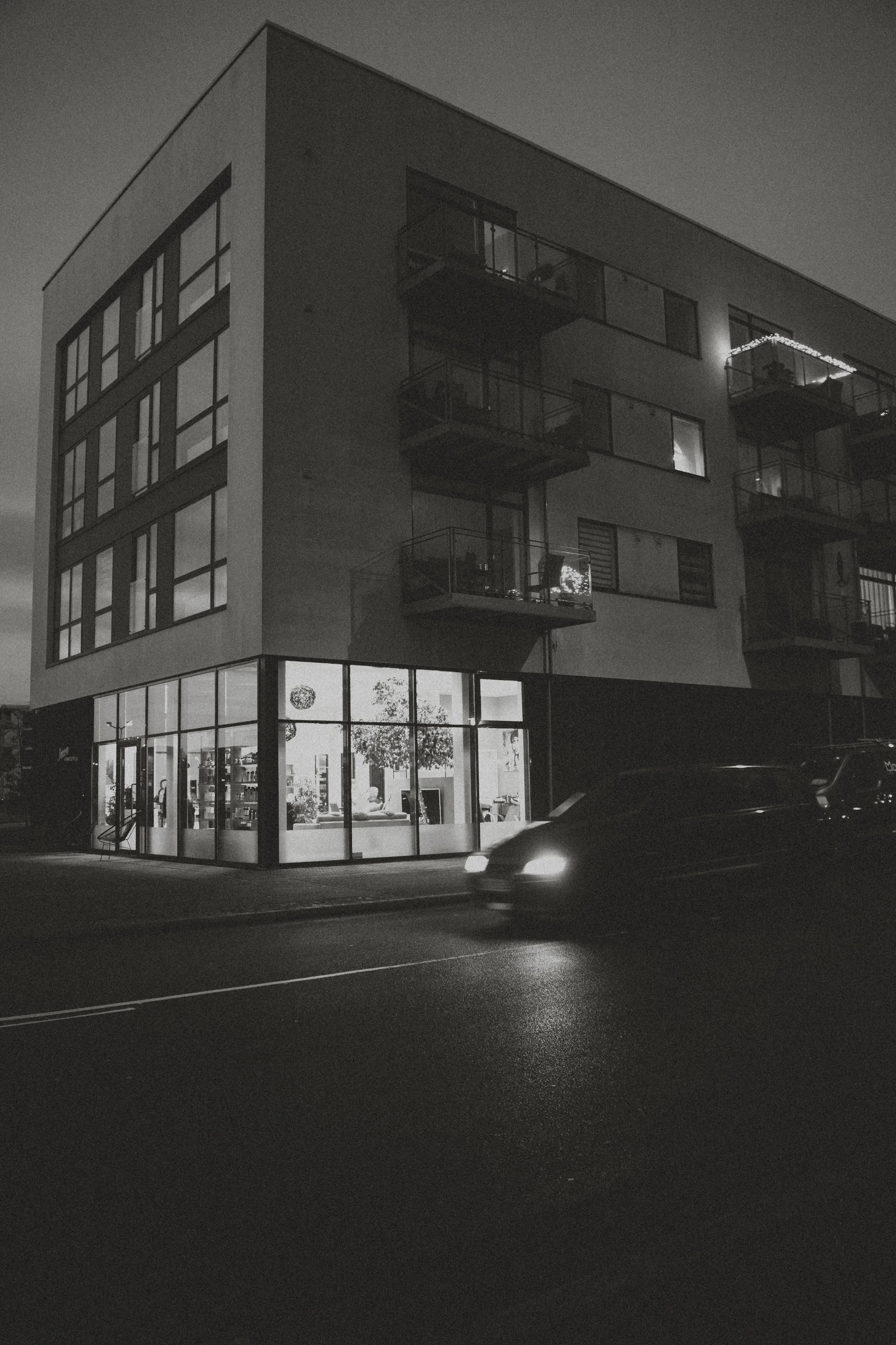 Modern building with glowing storefront at night