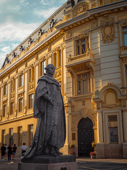 Statue in front of a grand historic building
