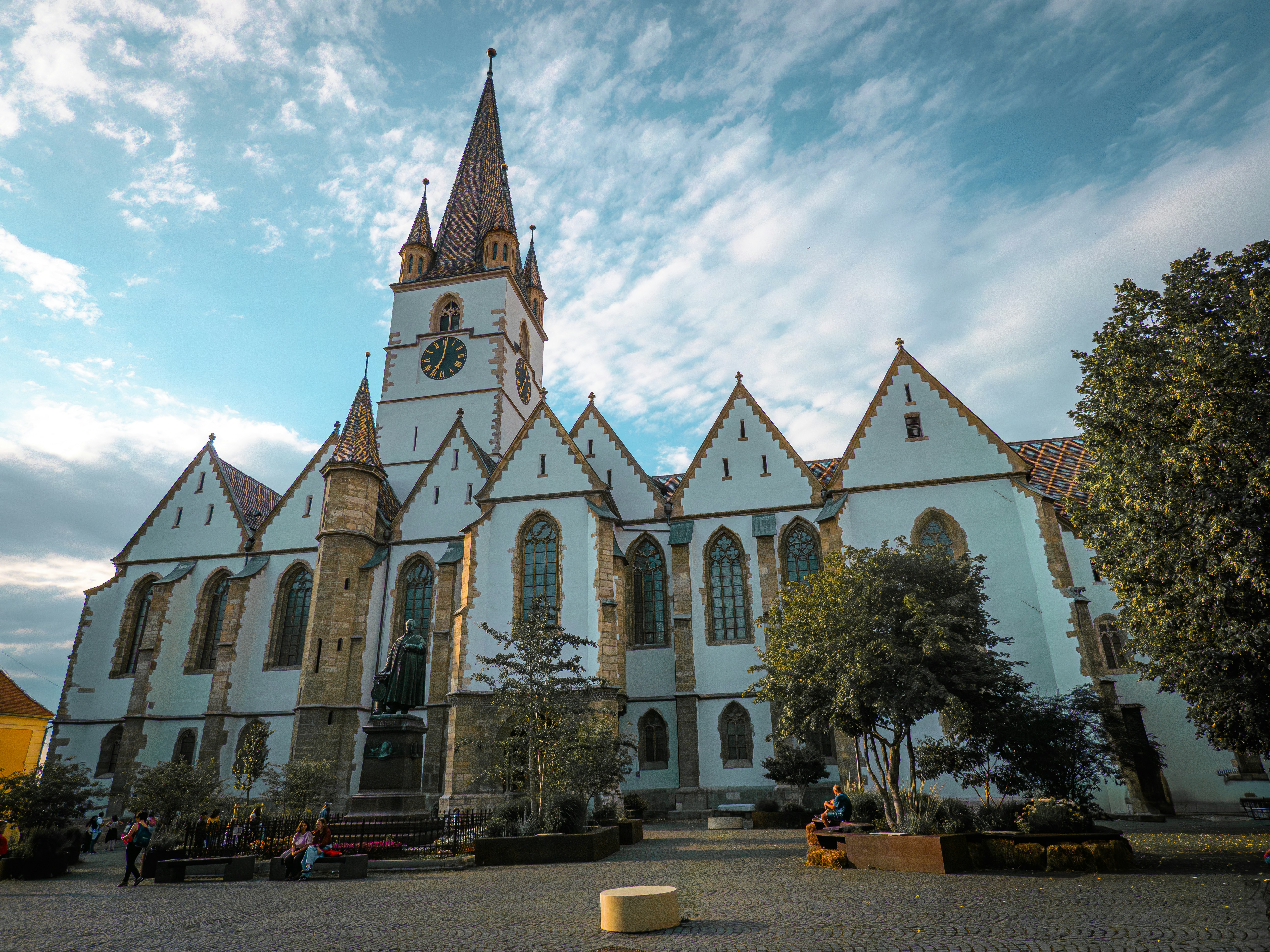 Ornate white church with a tall spire against sky