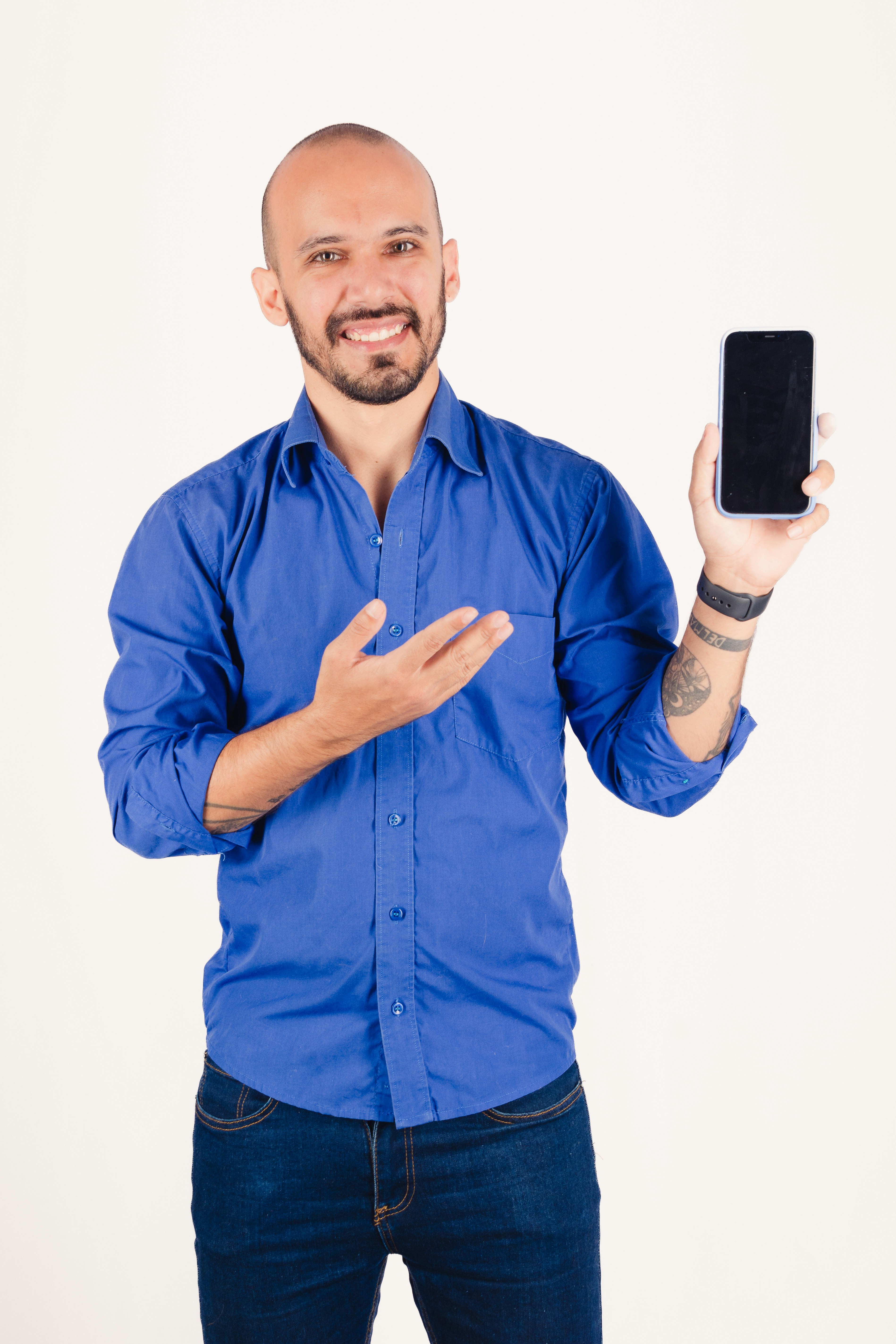 Man in blue shirt holding a smartphone