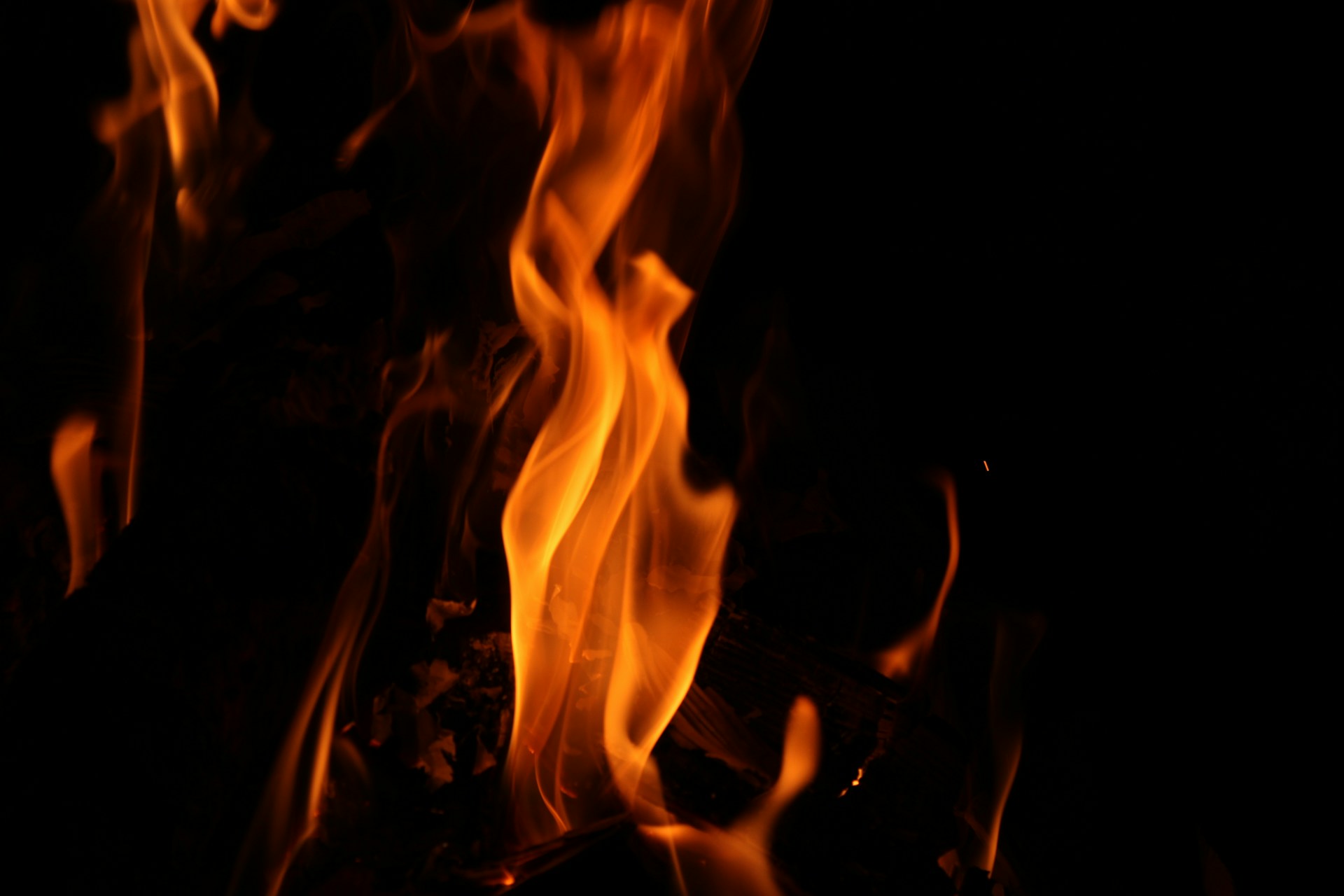 Fiery flames burning brightly against a dark background