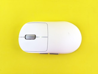 White computer mouse on a yellow background