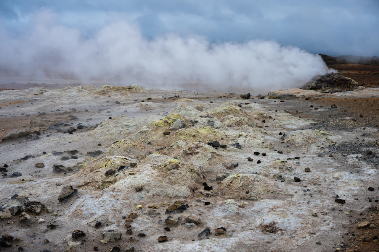 Geothermal steam vents rising from a rocky landscape