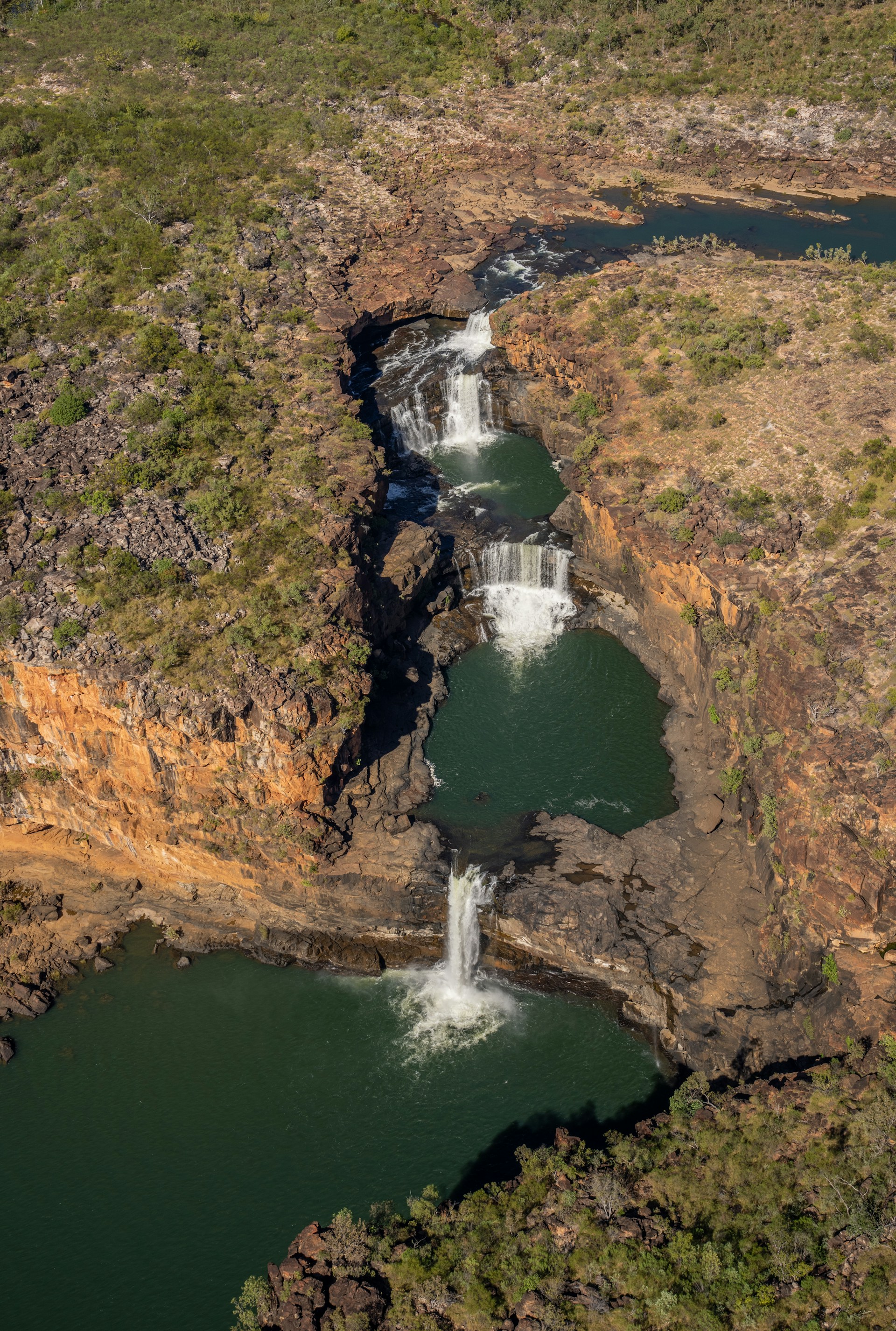Aerial view of a waterfall cascading into a pool