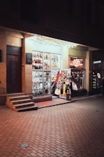 A brightly lit store at night with products displayed.