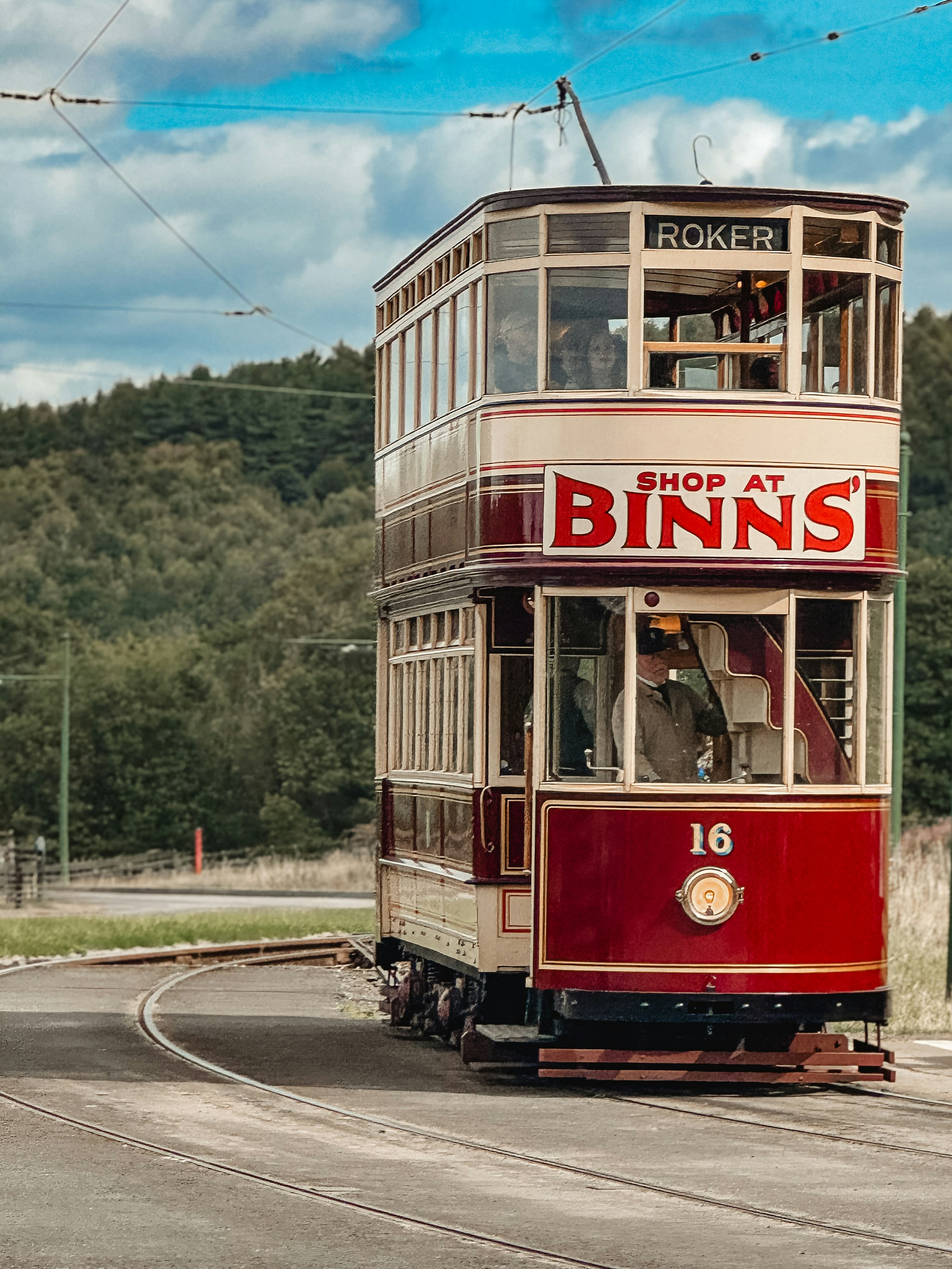 Vintage double-decker tram on a track.