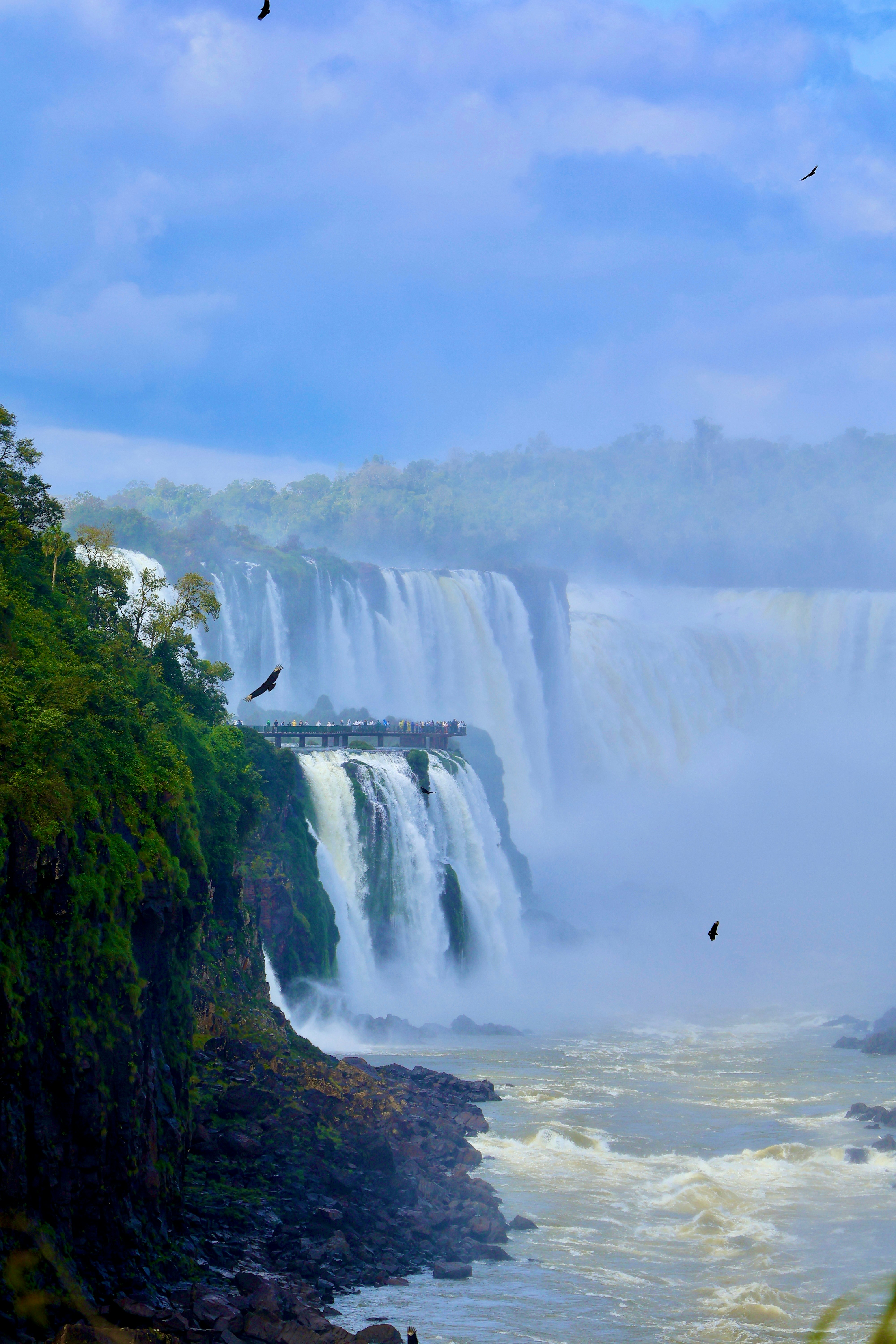 Majestic waterfalls cascade down lush green cliffs