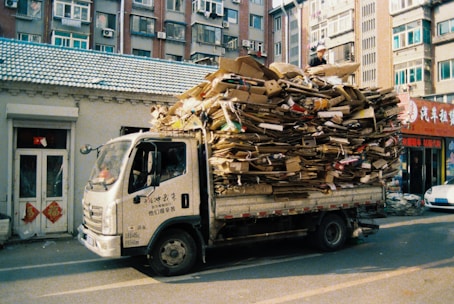 Truck loaded with cardboard boxes on city street