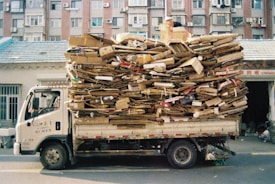 Truck overloaded with firewood driving on street