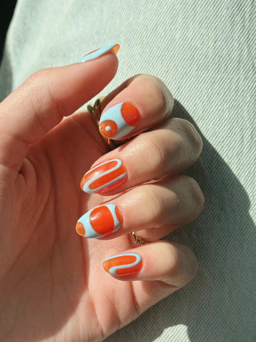 Finished set with blue and orange abstract swirl nail art