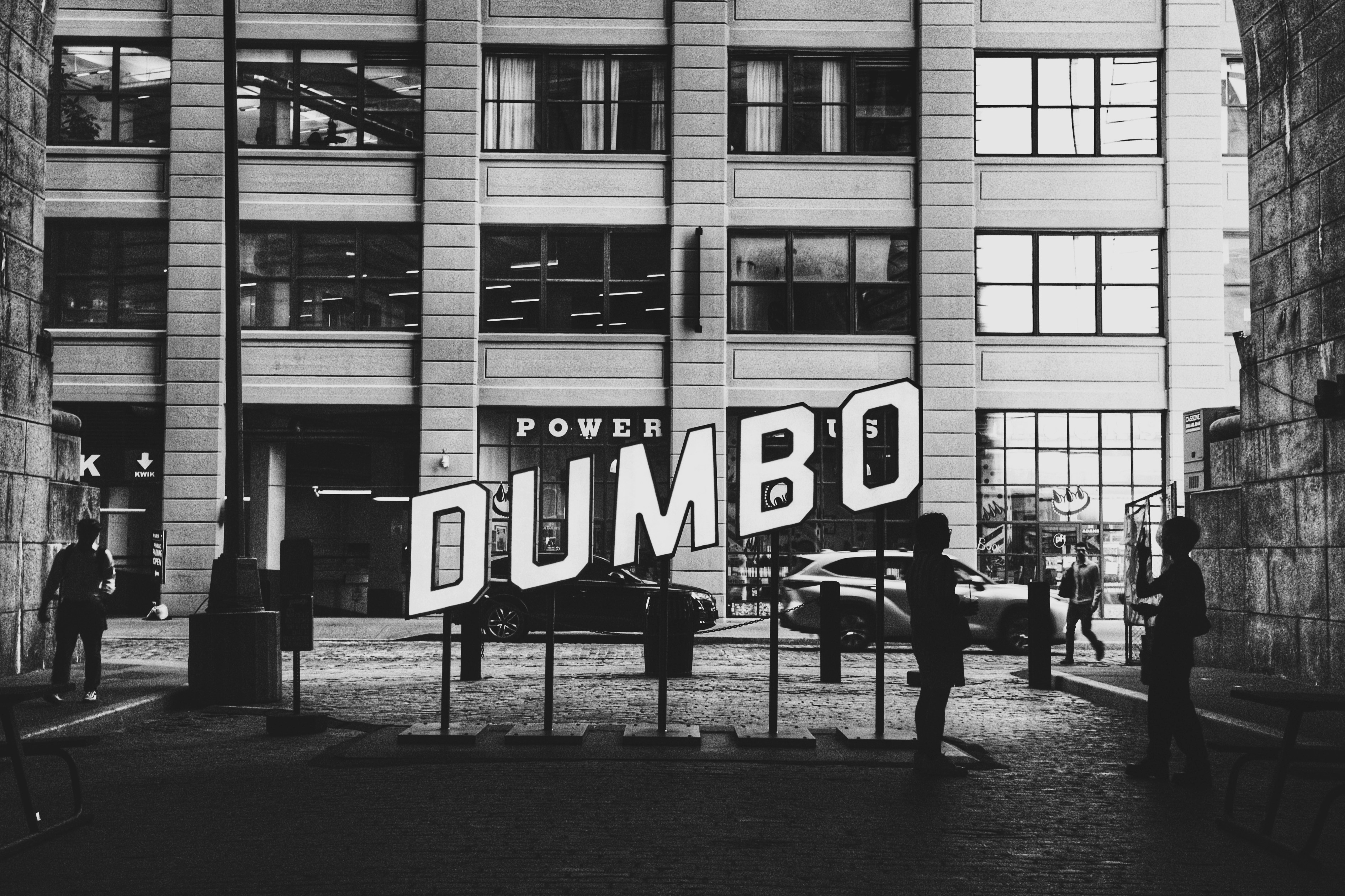 Dumbo sign with buildings and people in black and white photo – Free ...