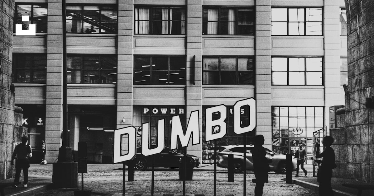 Dumbo sign with buildings and people in black and white photo – Free ...