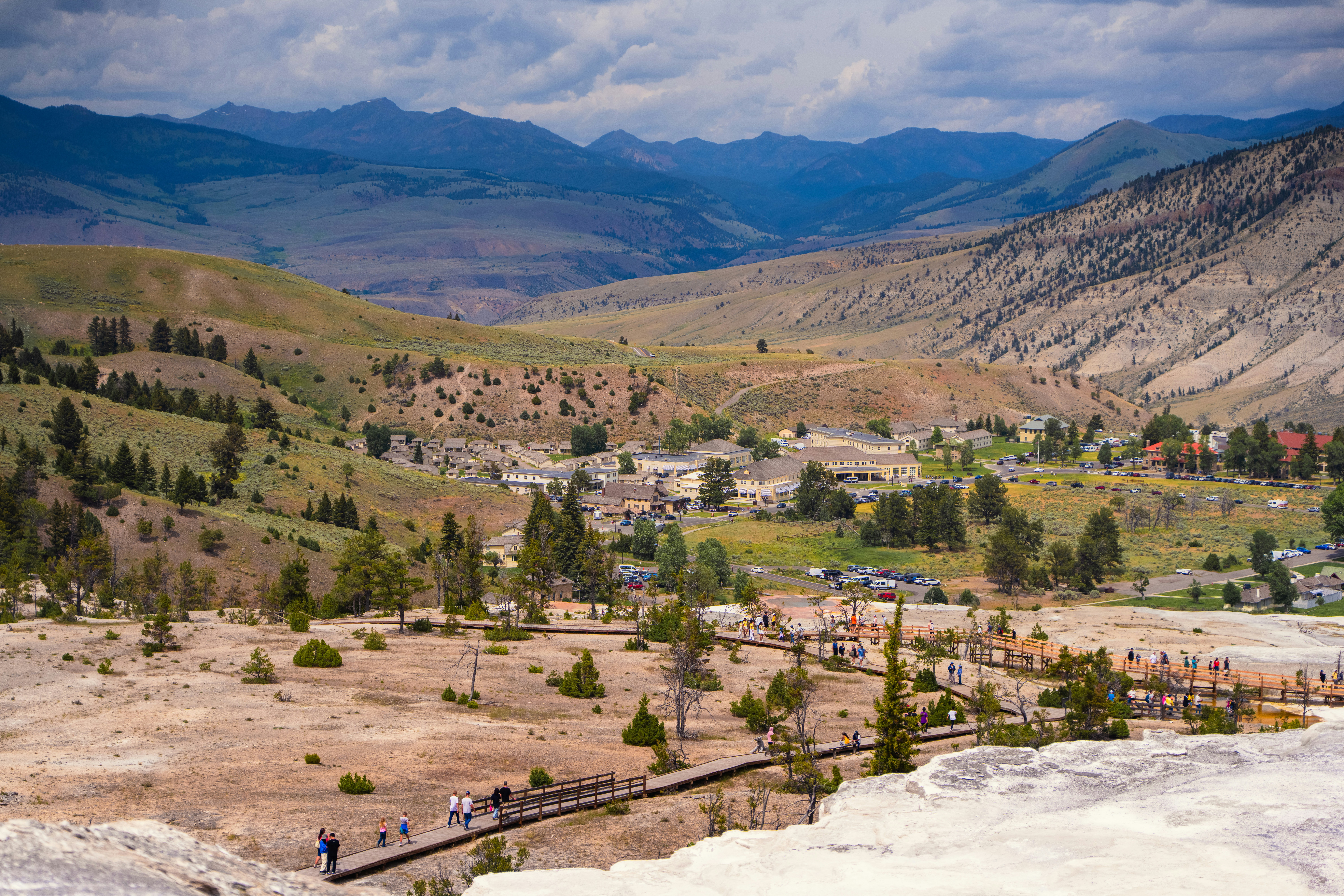 Valley with geothermal terraces and distant mountains