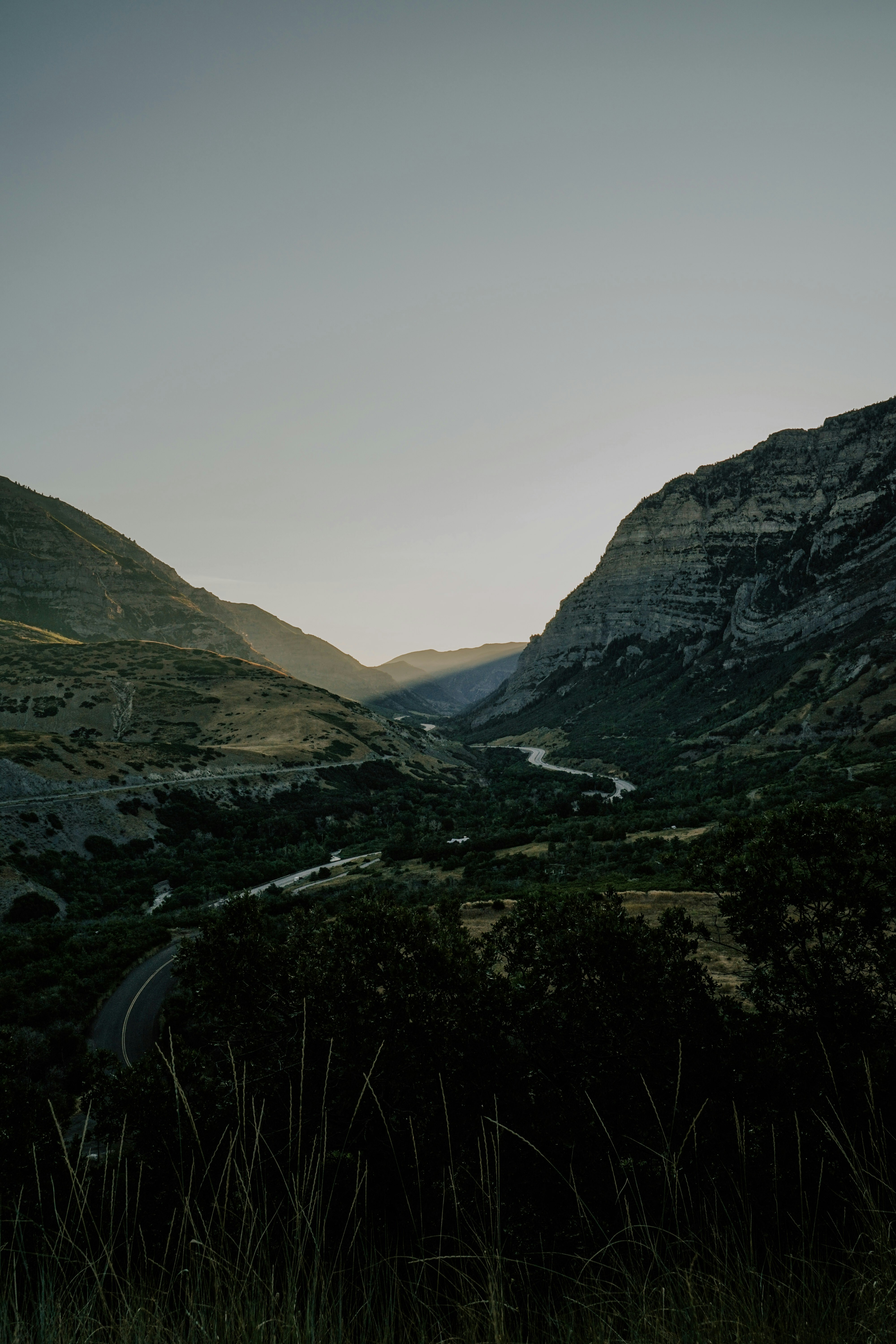 Serene mountain valley with winding road at dusk