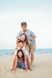 Family stacked on each other at the beach