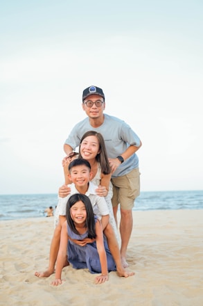 Family stacked on each other at the beach