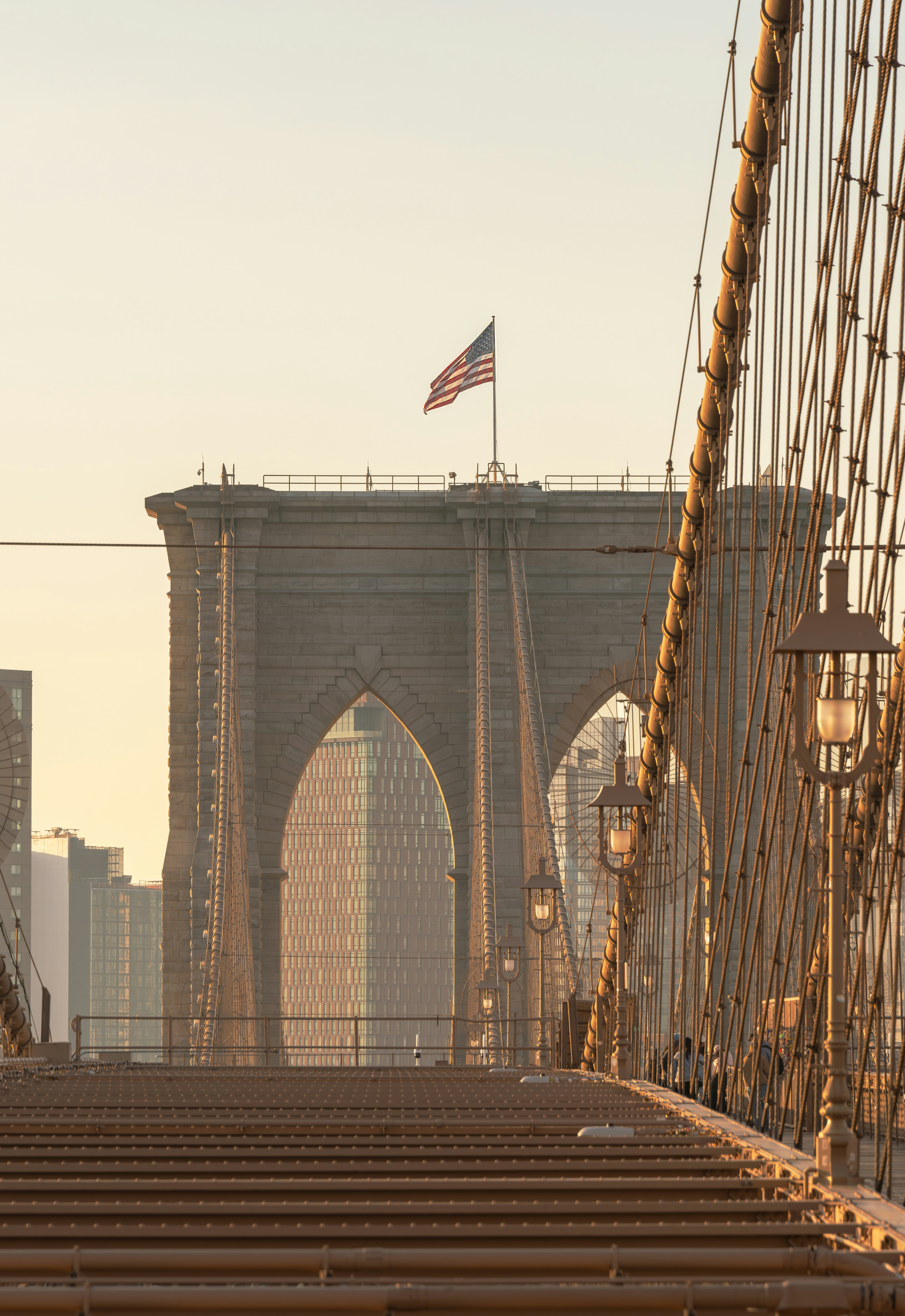 Brooklyn bridge with american flag at sunrise