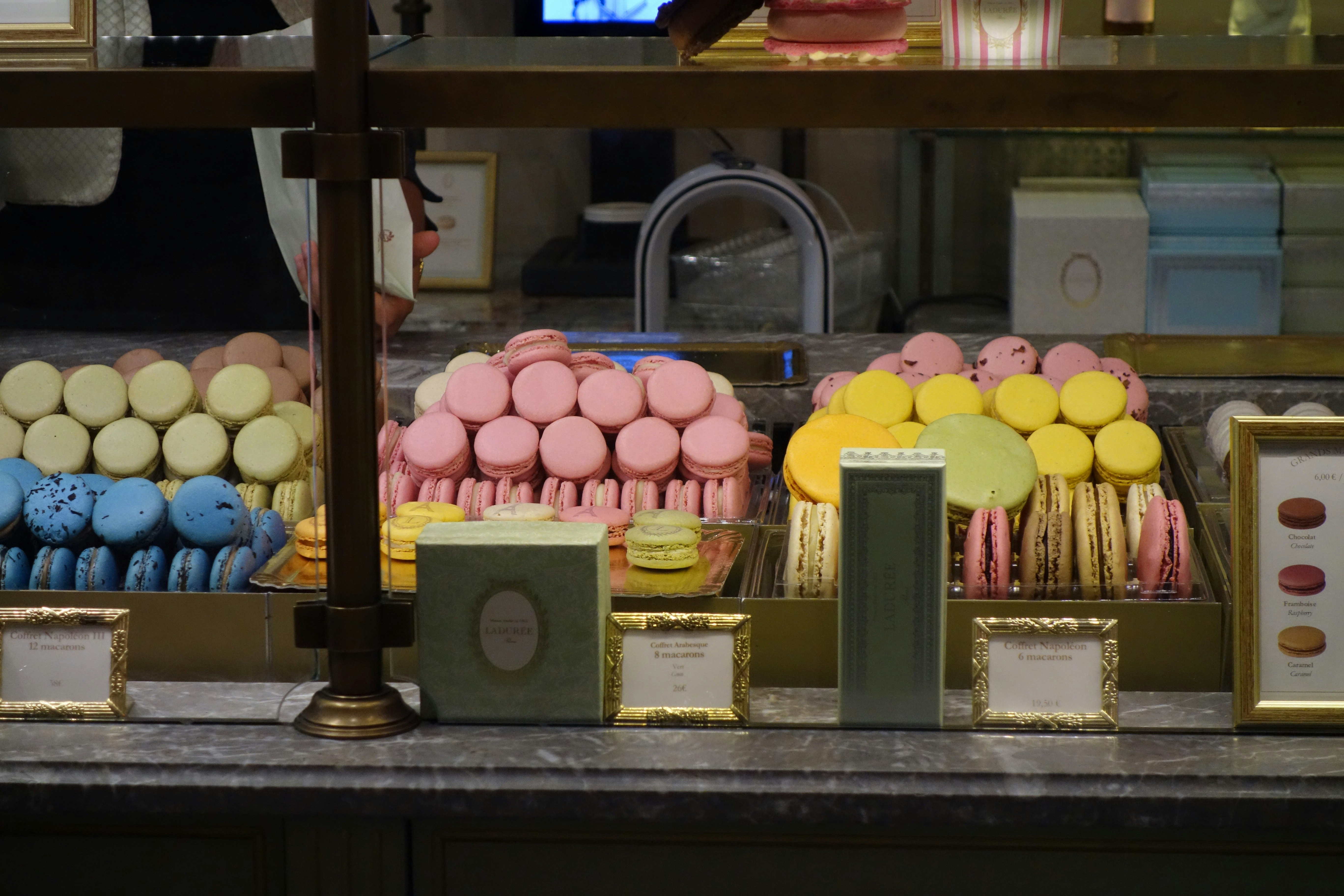 Colorful display of macarons at a Parisian patisserie - things to do in paris