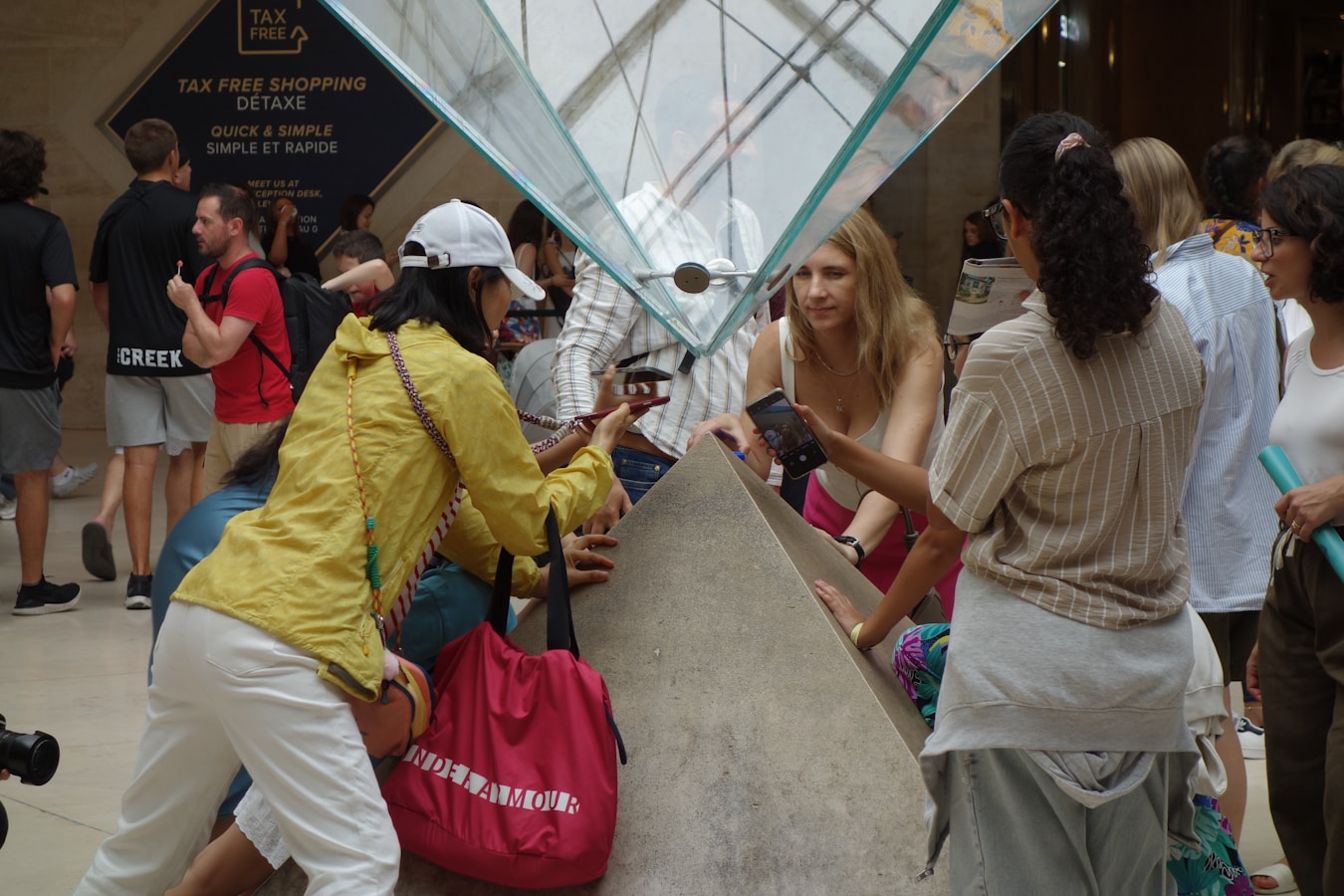 People gathered around a large structure indoors