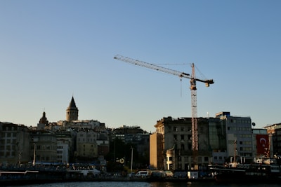 City skyline with a crane against a clear blue sky