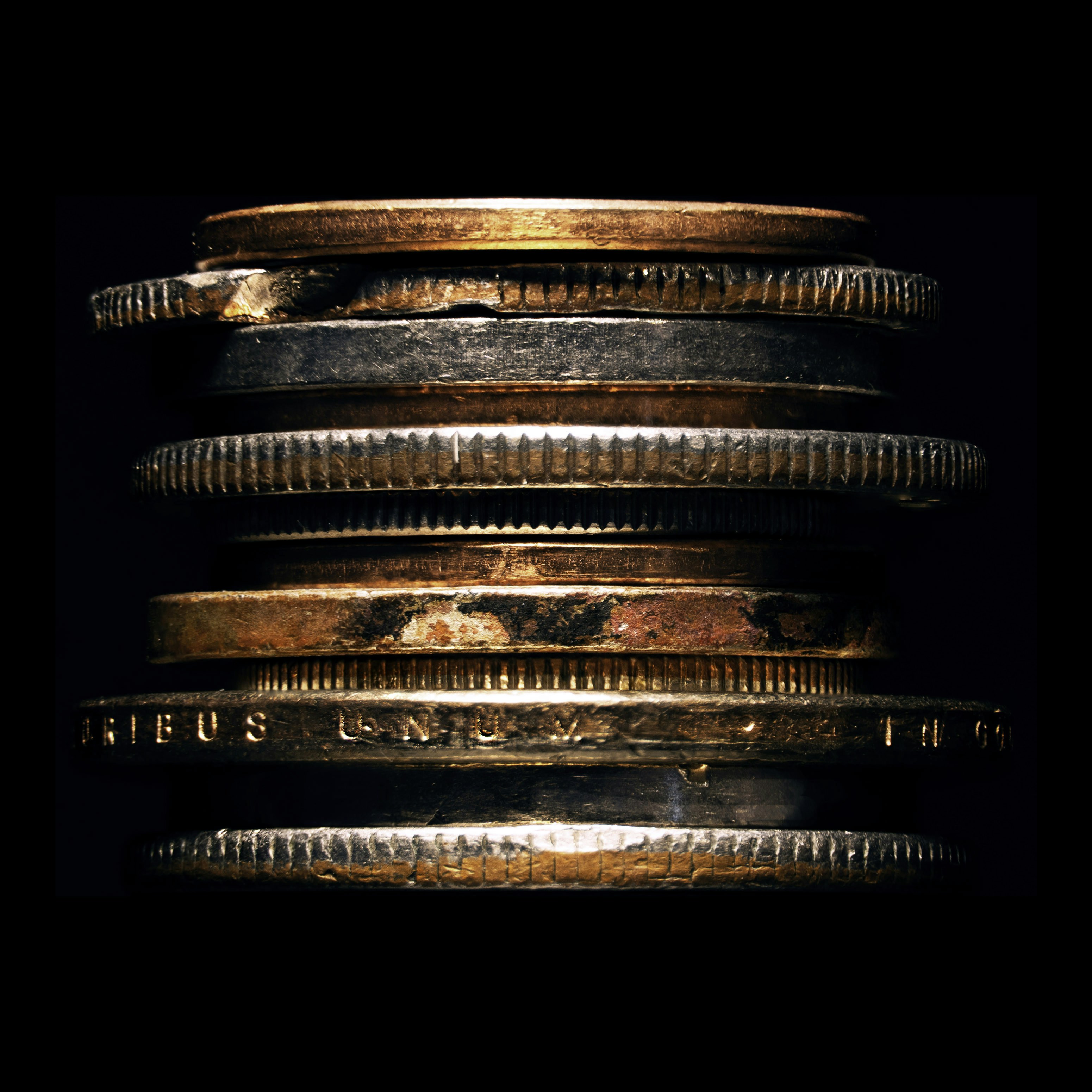 Stack of copper coins against black background
