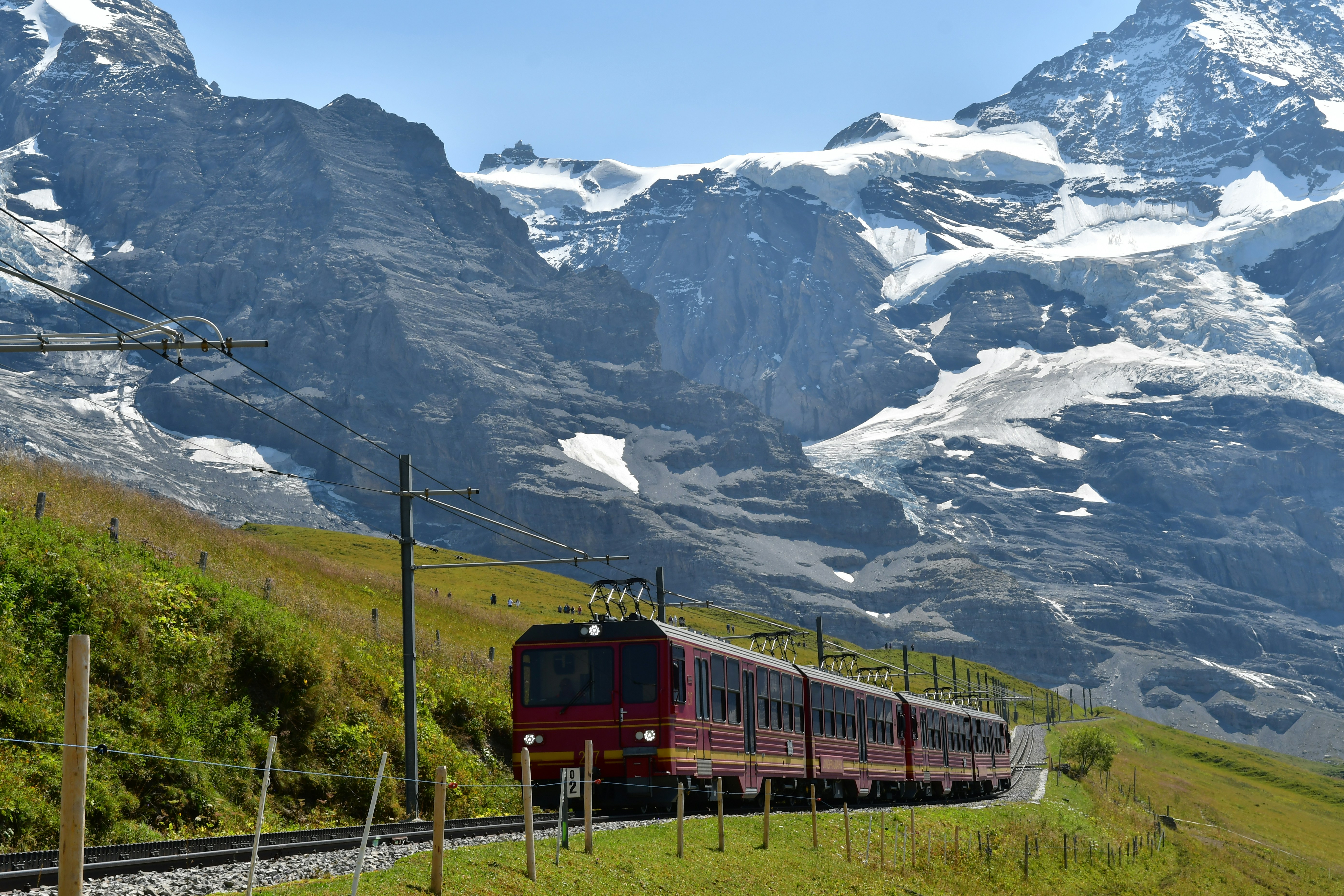 Train travels through scenic mountains with snow