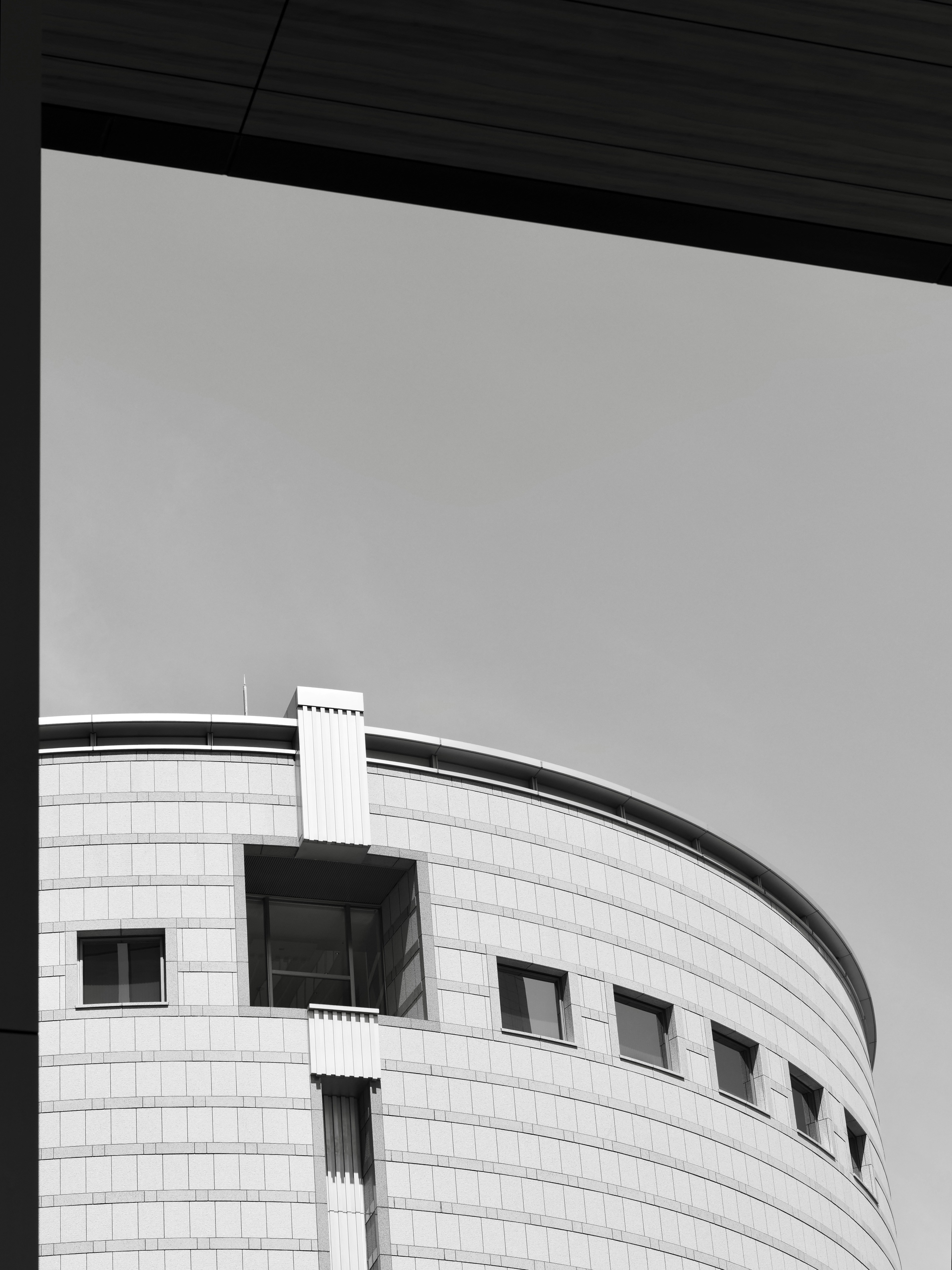 Modern building with rounded architecture against sky