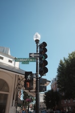 Traffic light and street sign against a blue sky