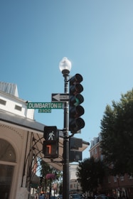 Traffic light and street sign against a blue sky