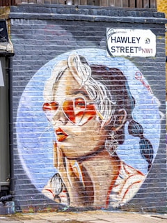 Graffiti art of a woman's face on a brick wall.