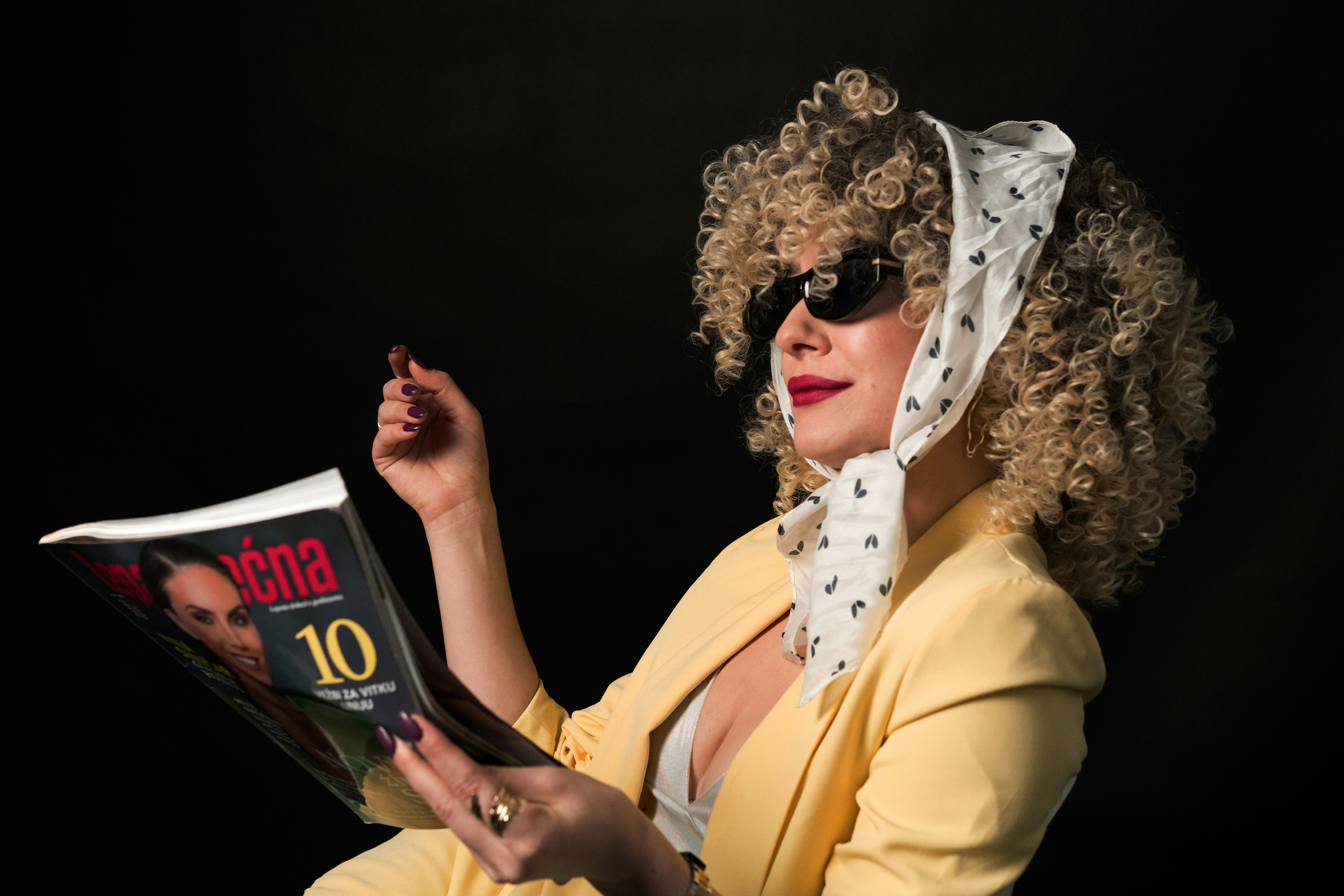 Stylish woman reading a newspaper