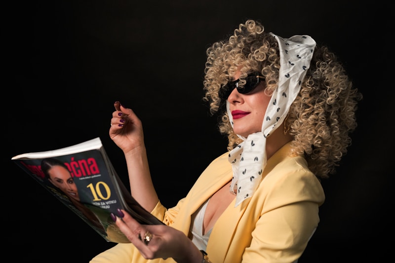Woman in sunglasses reading a magazine