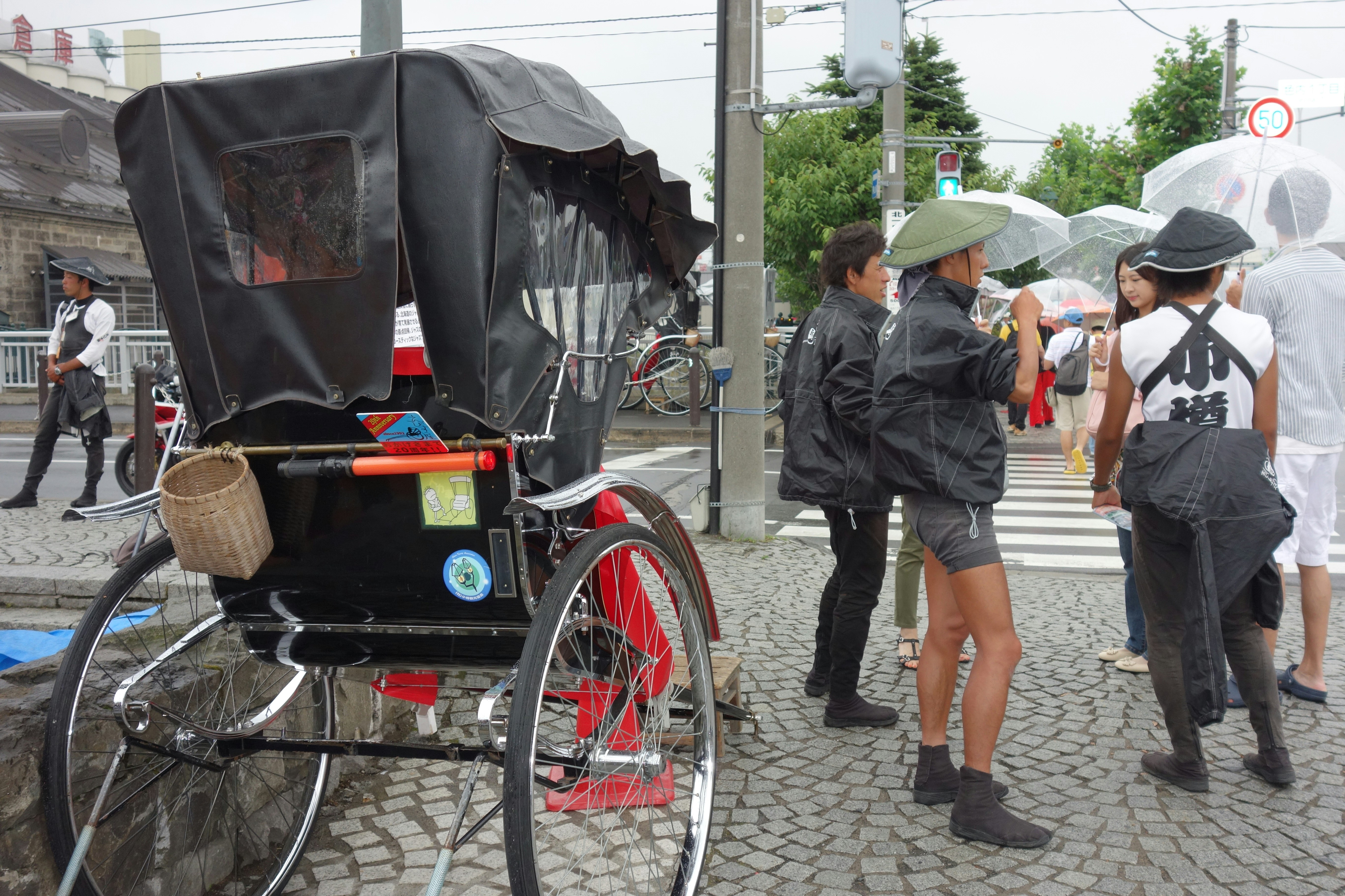 People gathered near a camera setup on a street.