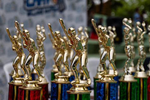 Row of golden trophies with colorful bases