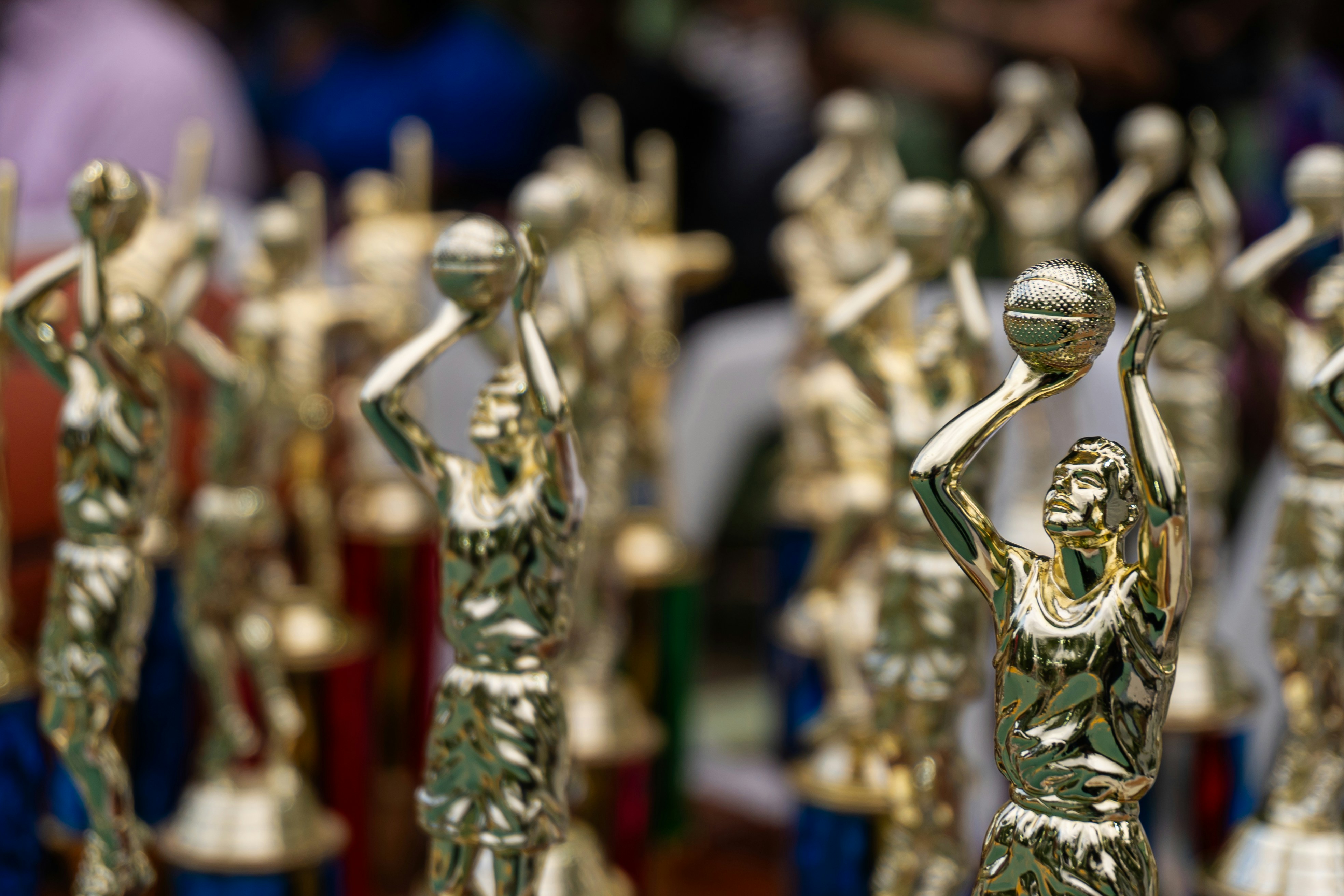 Row of golden trophies with blurred background
