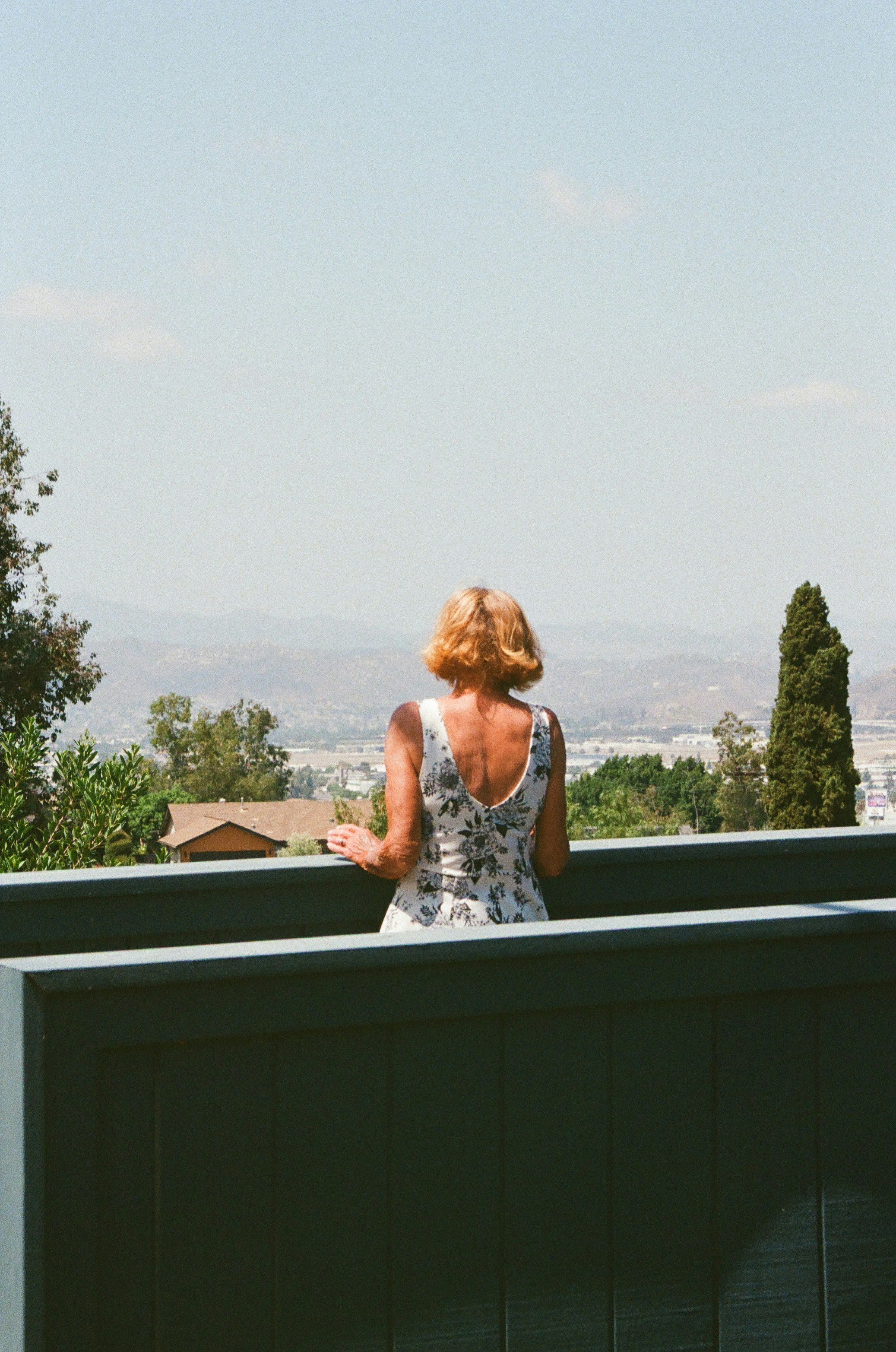 Woman in dress looking out at landscape